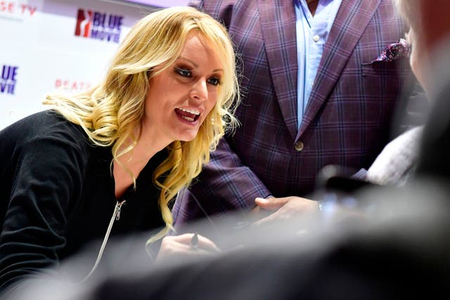 <p>Adult film actress Stormy Daniels signs autographs at the Venus Fair for Erotic Entertainment and Lifestyle on October 12, 2018, in Berlin</p>