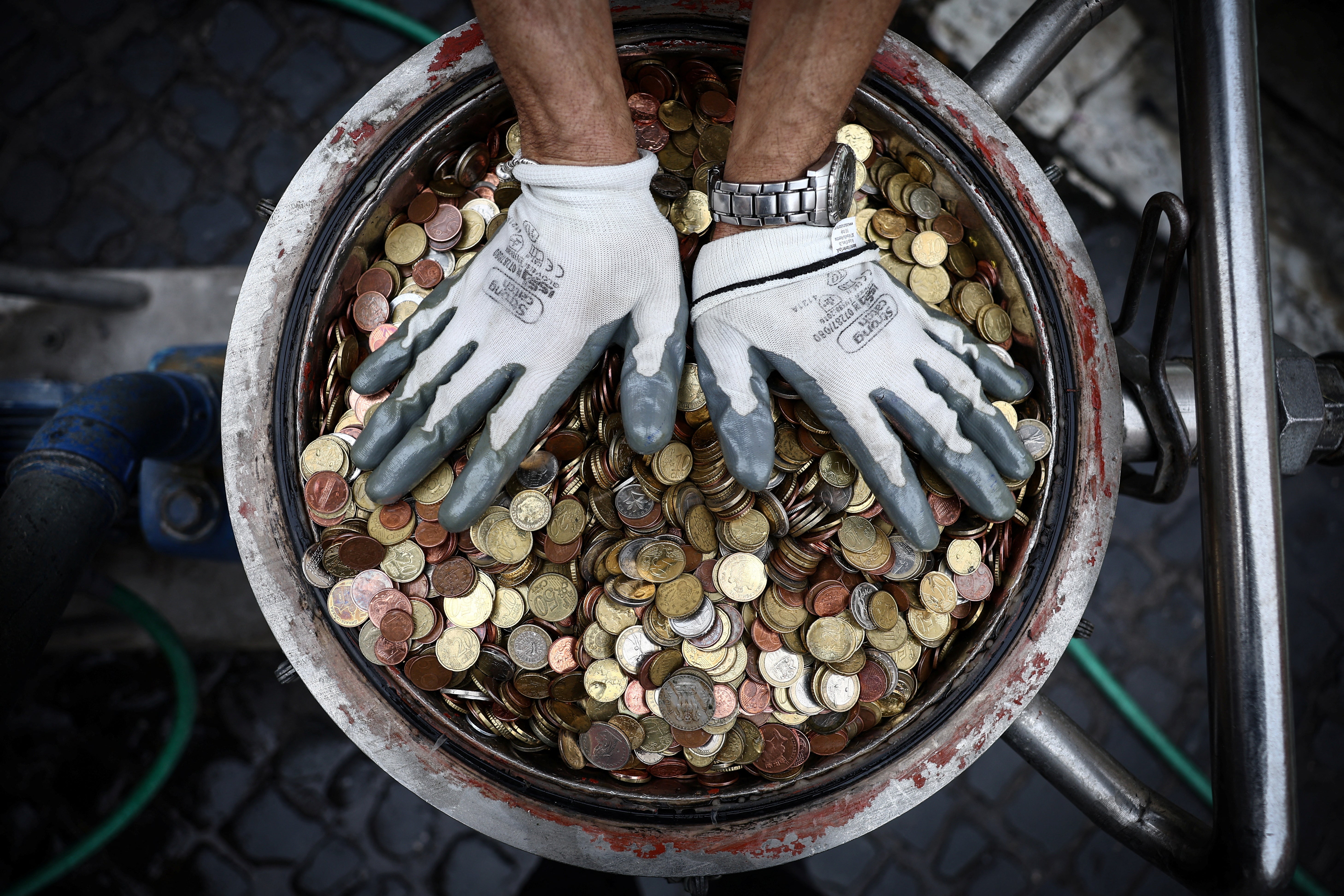 Coins are pictured after having been collected from the Trevi Fountain in Rome