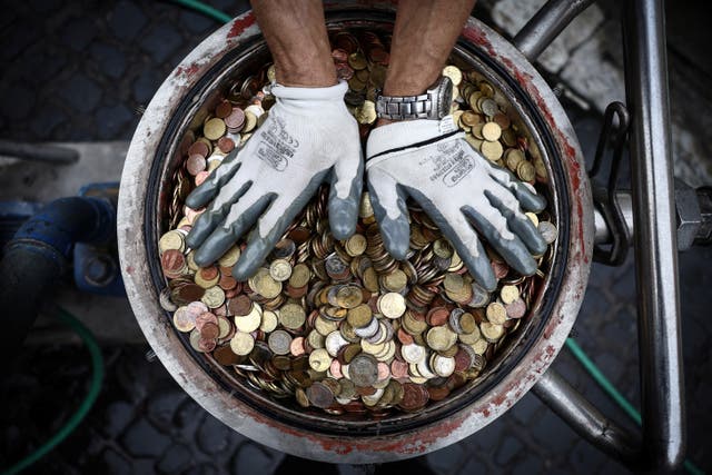 <p>Coins are pictured after having been collected from the Trevi Fountain in Rome</p>
