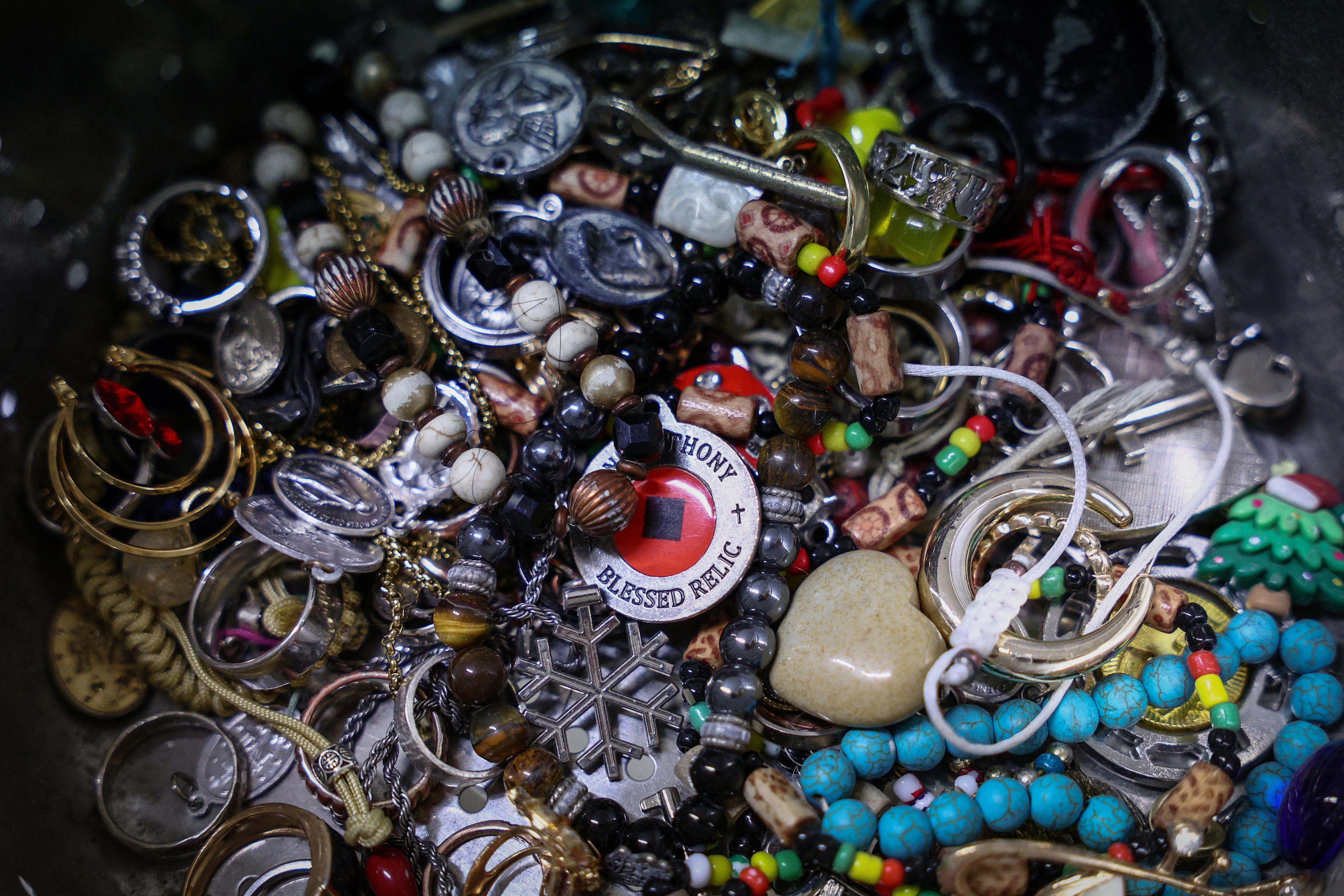 Items collected alongside the coins are pictured at the office of the Catholic charity Caritas