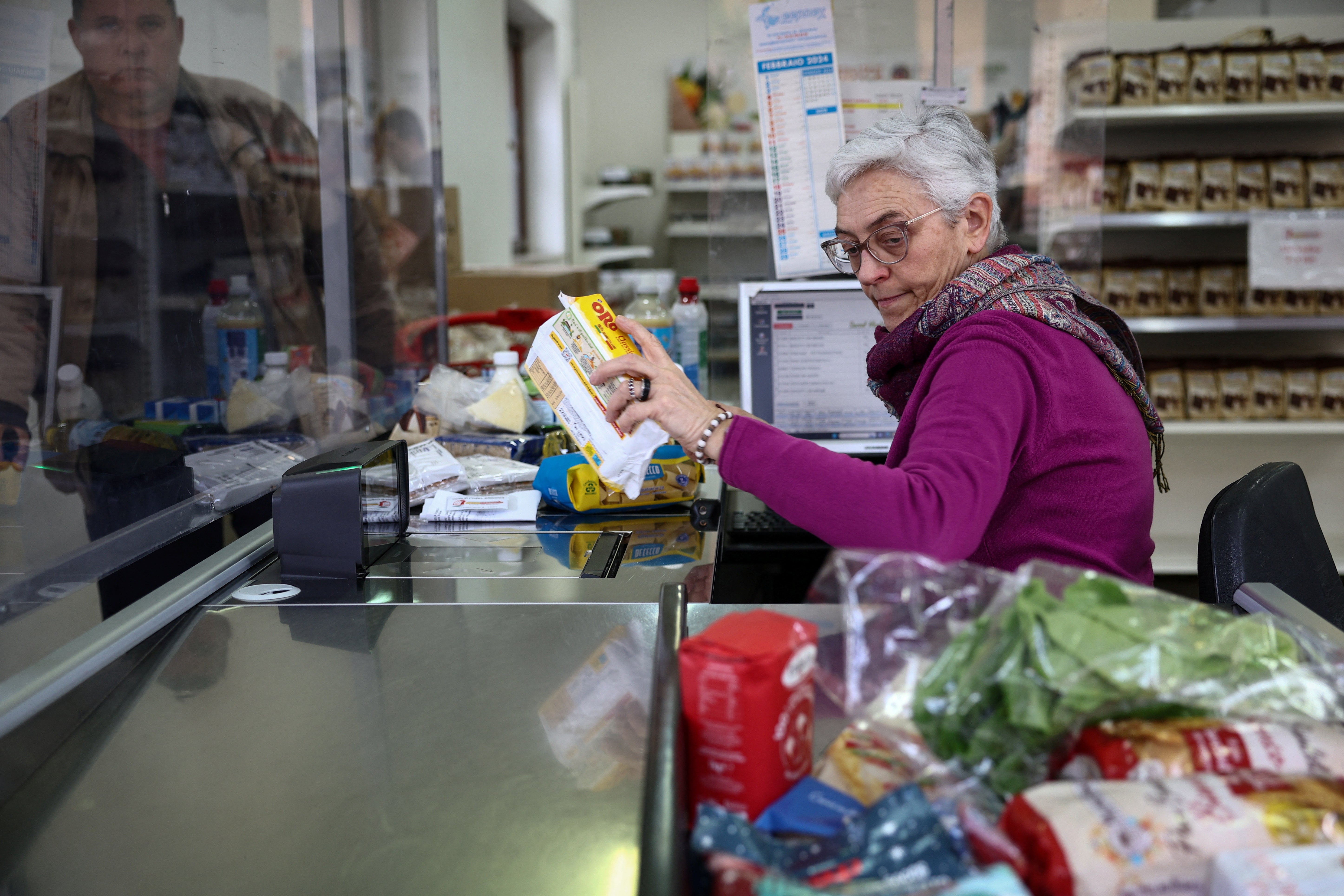 Volunteer Antonella Rota works at Caritas Emporium, a supermarket financed with money collected from the fountain