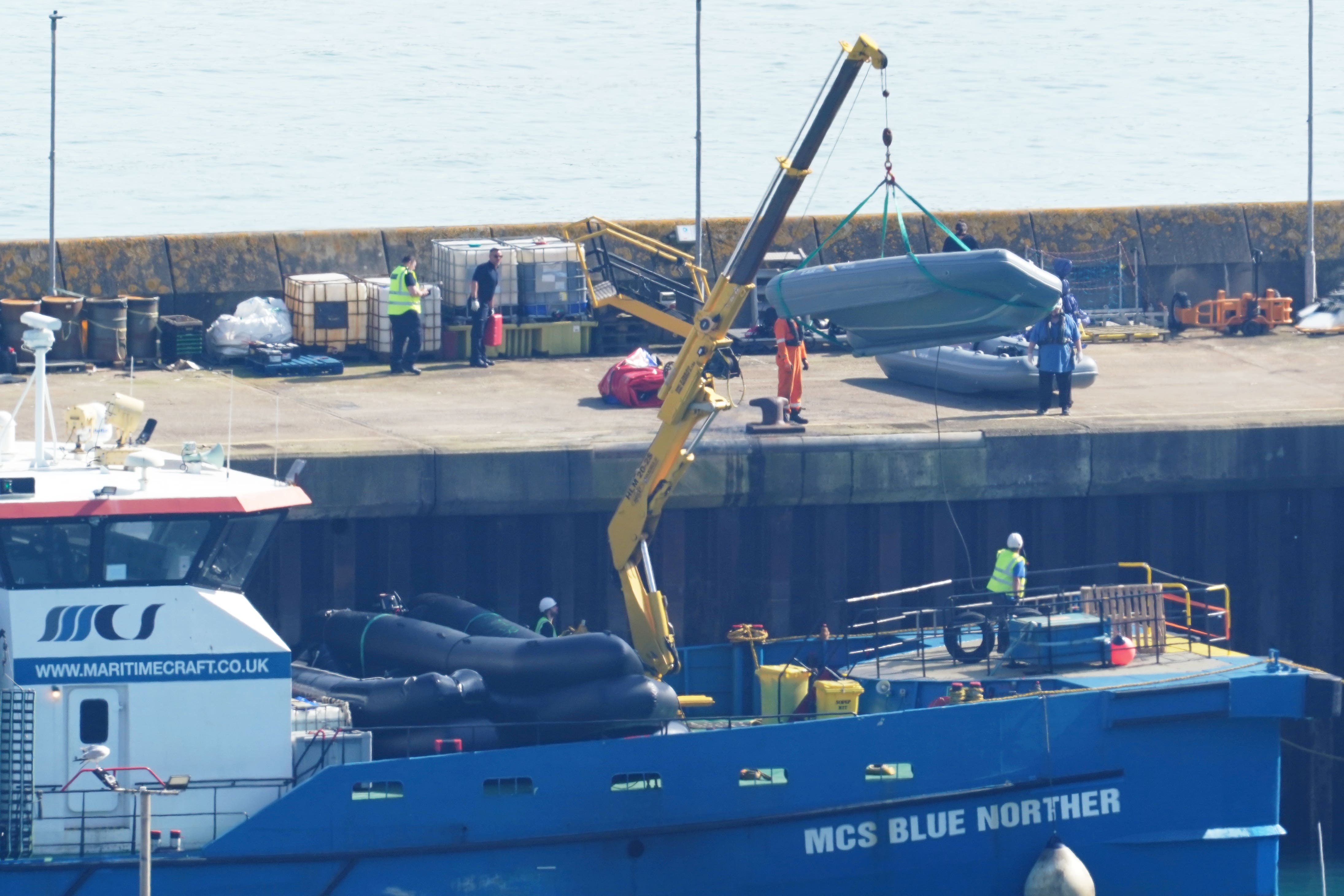 Boats used by people thought to be migrants are lifted on to the quayside in Dover, Kent (Gareth Fuller/PA)