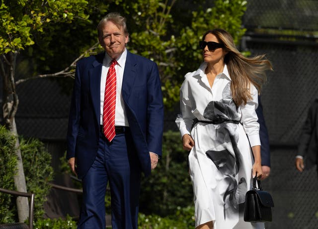 <p>Former US President Donald Trump and former first lady Melania Trump walk together as they prepare to vote at a polling station in Florida</p>