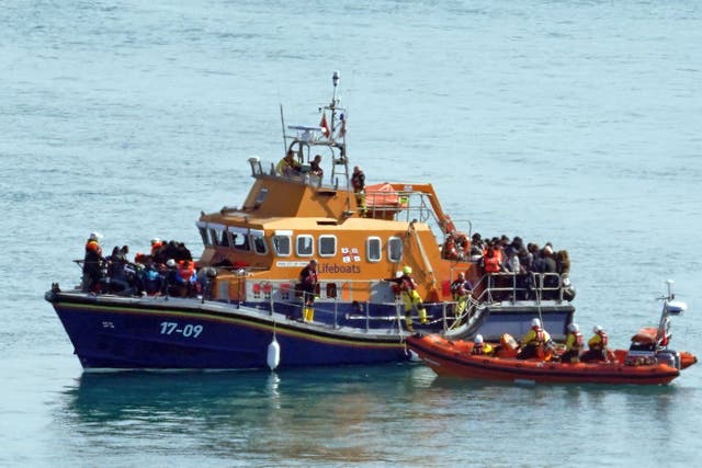 <p>A group of people thought to be migrants are brought in to Dover, Kent, onboard the RNLI Dover Lifeboat following a small boat incident in the Channel (Gareth Fuller/PA)</p>