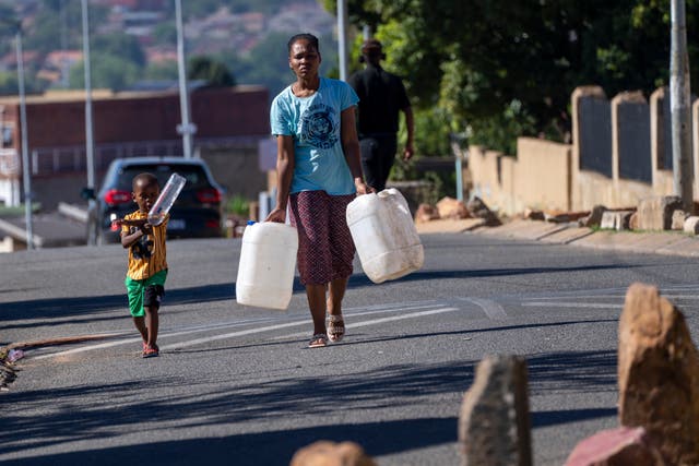 <p>Residents of the township of Soweto, South Africa, queue for water Saturday, March 16, 2024</p>