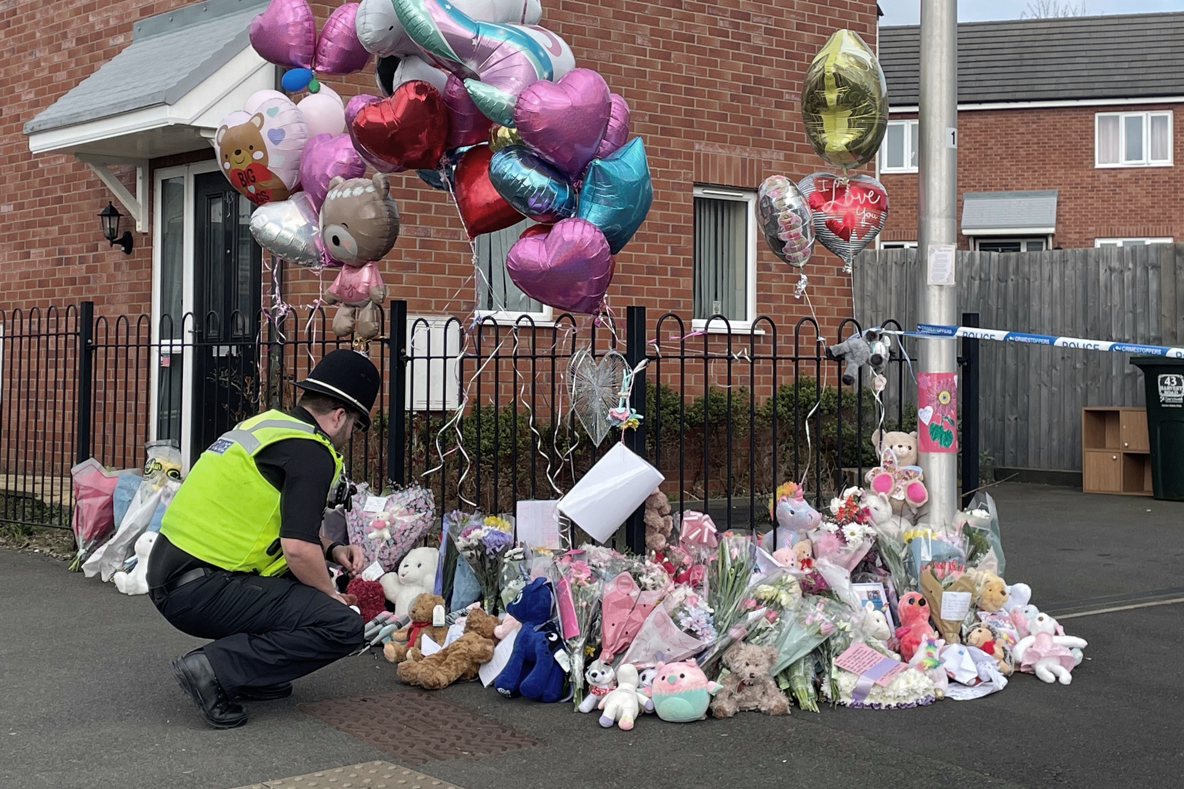 Floral tributes are left at the entrance to Robin Close in Rowley Regis (Matthew Cooper/PA)