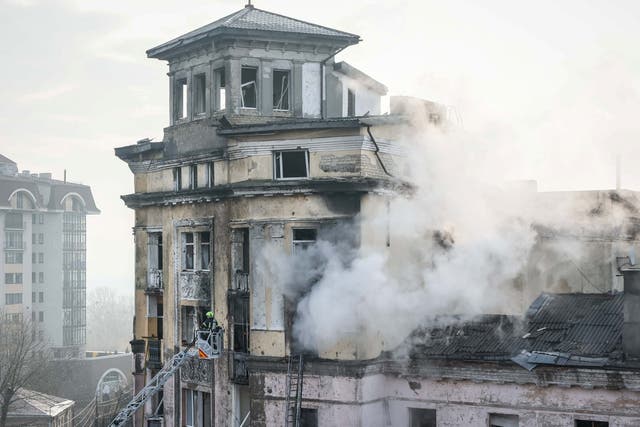 <p>Rescuers work at the site of a building damaged during a Russian missile attack on Kyiv</p>