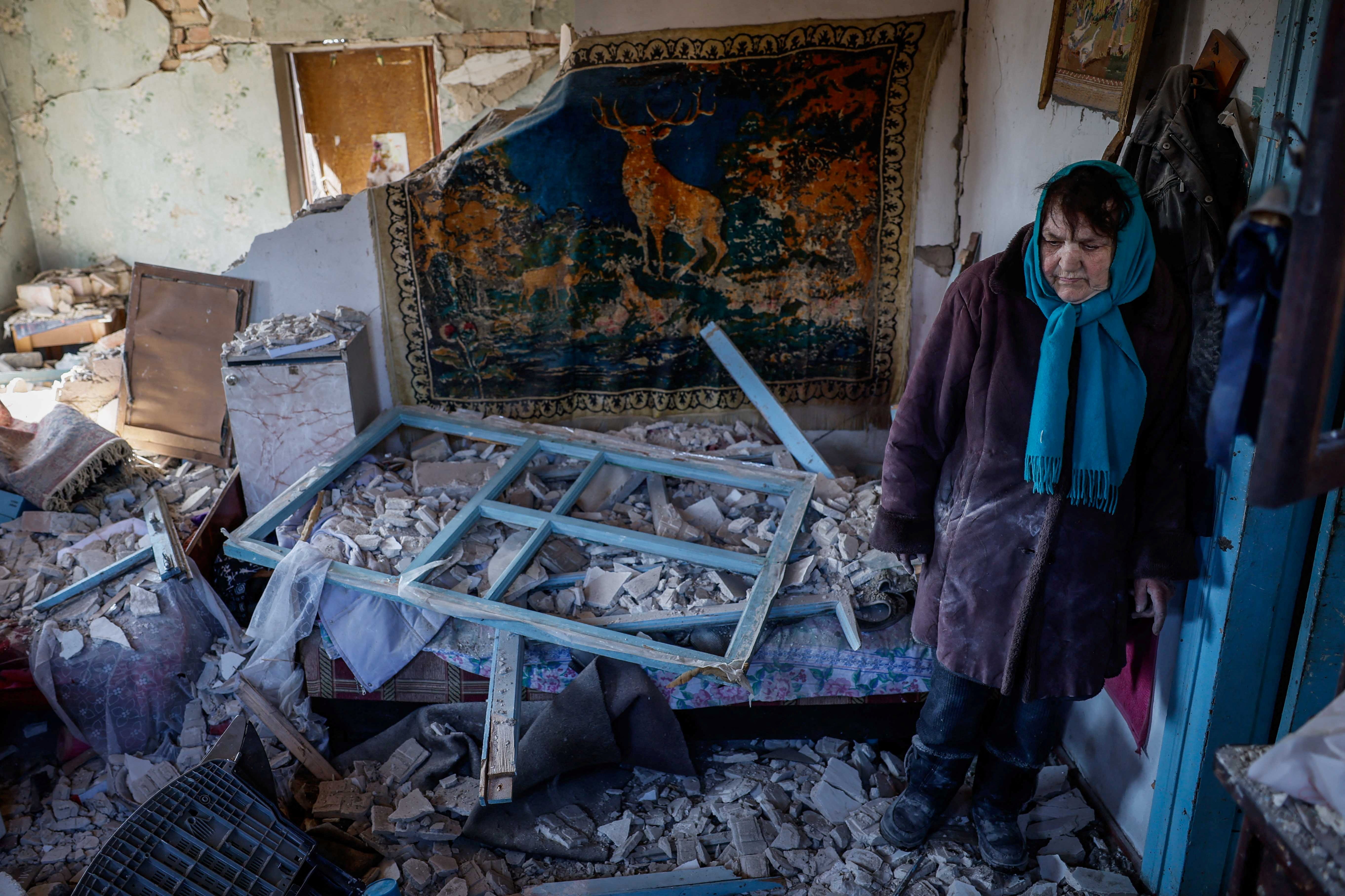 Tetiana, 67, stands in her house, which was destroyed by a Russian missile strike near Kyiv