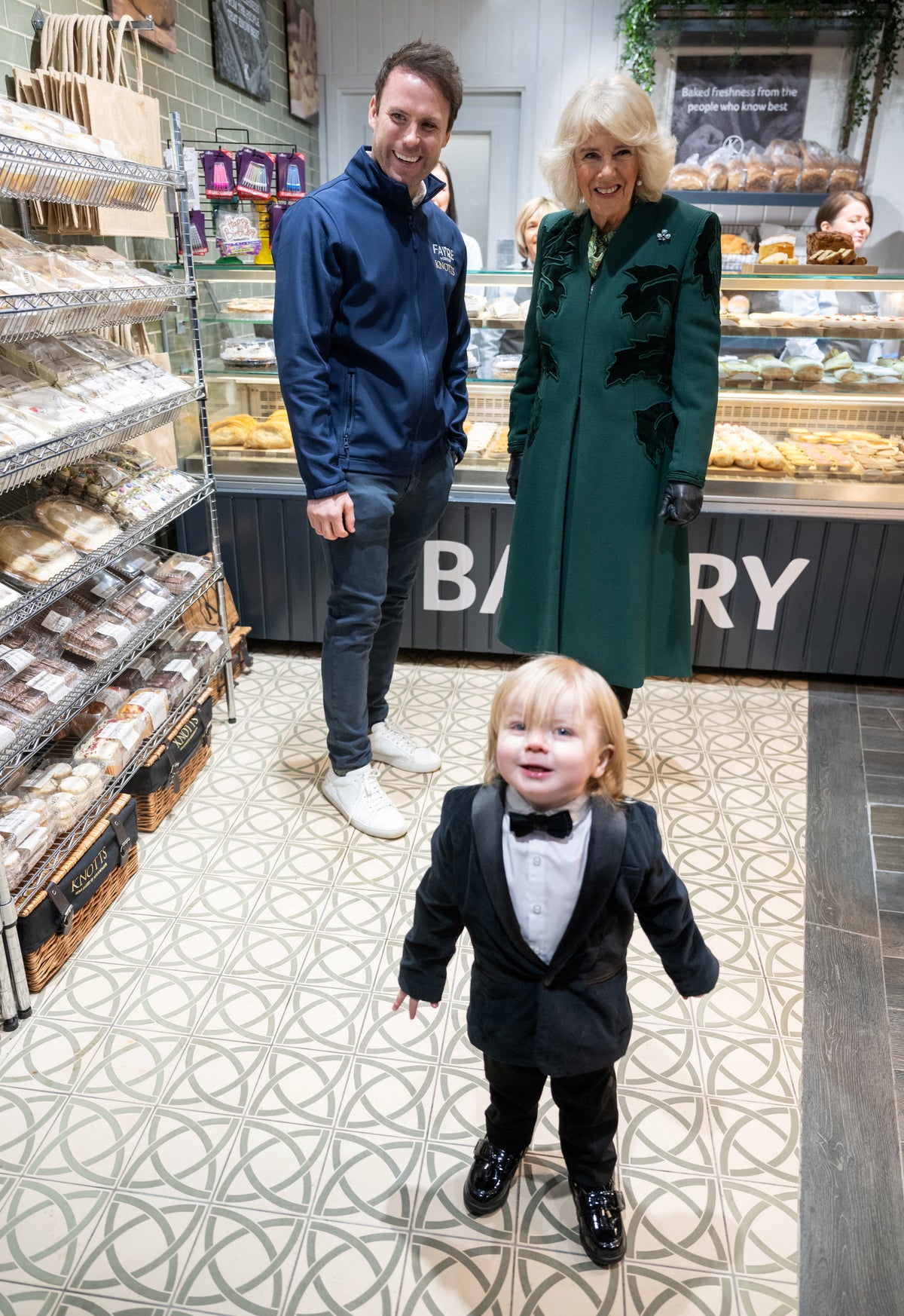 Parents of tuxedo toddler who photobombed Queen on bakery visit reveal Camilla’s response