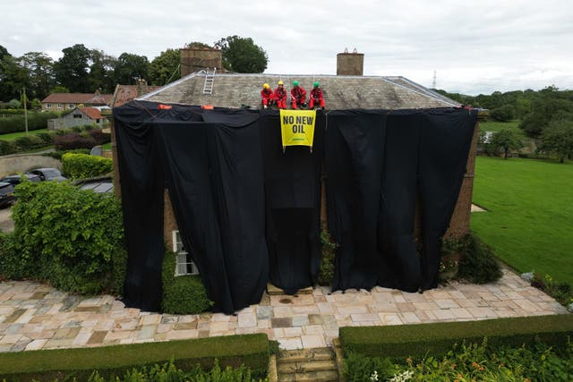 <p>Activists on the roof of Prime Minister Rishi Sunak’s house in North Yorkshire in 2023 (Danny Lawson/PA)</p>