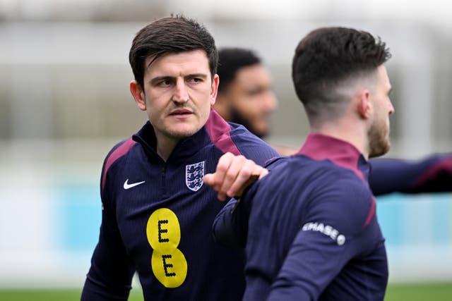 <p>Harry Maguire warms up before training at St George’s Park this week</p>