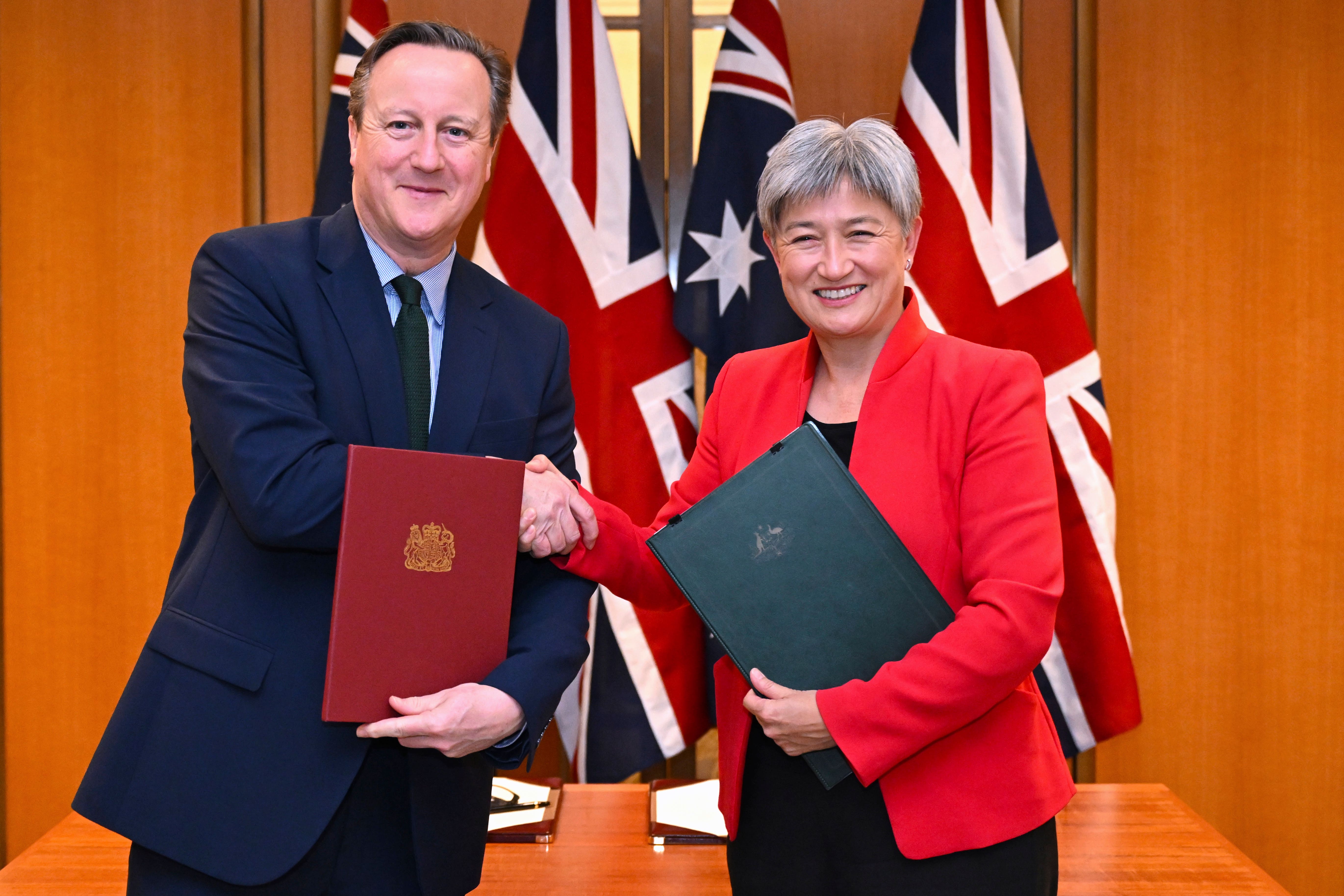 Britain’s Foreign Secretary David Cameron and Australian Foreign Minister Penny Wong after signing an agreement at Parliament House in Canberra (Lukas Coch/AAP Image/AP)