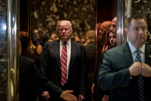 <p>Donald Trump rides the building’s lurid golden elevator </p>