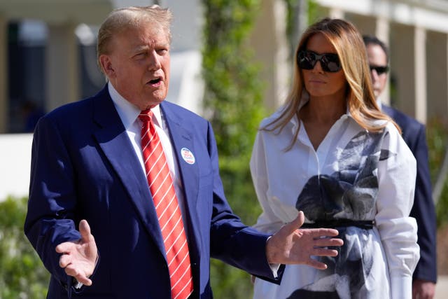 <p>Donald Trump and Melania Trump speak to the press after voting in the Florida primary election in Palm Beach on March 19. </p>