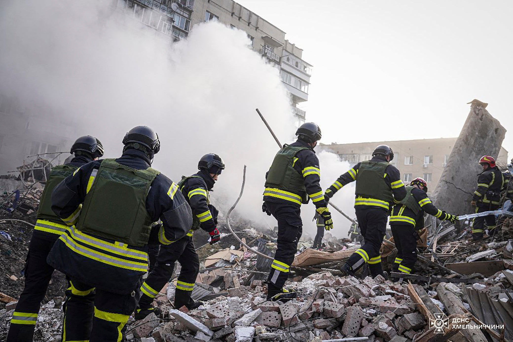 A handout photo made available by the State Emergency Service shows rescuers at work at the scene of a missile strike in the city of Khmelnytskyi, Ukraine