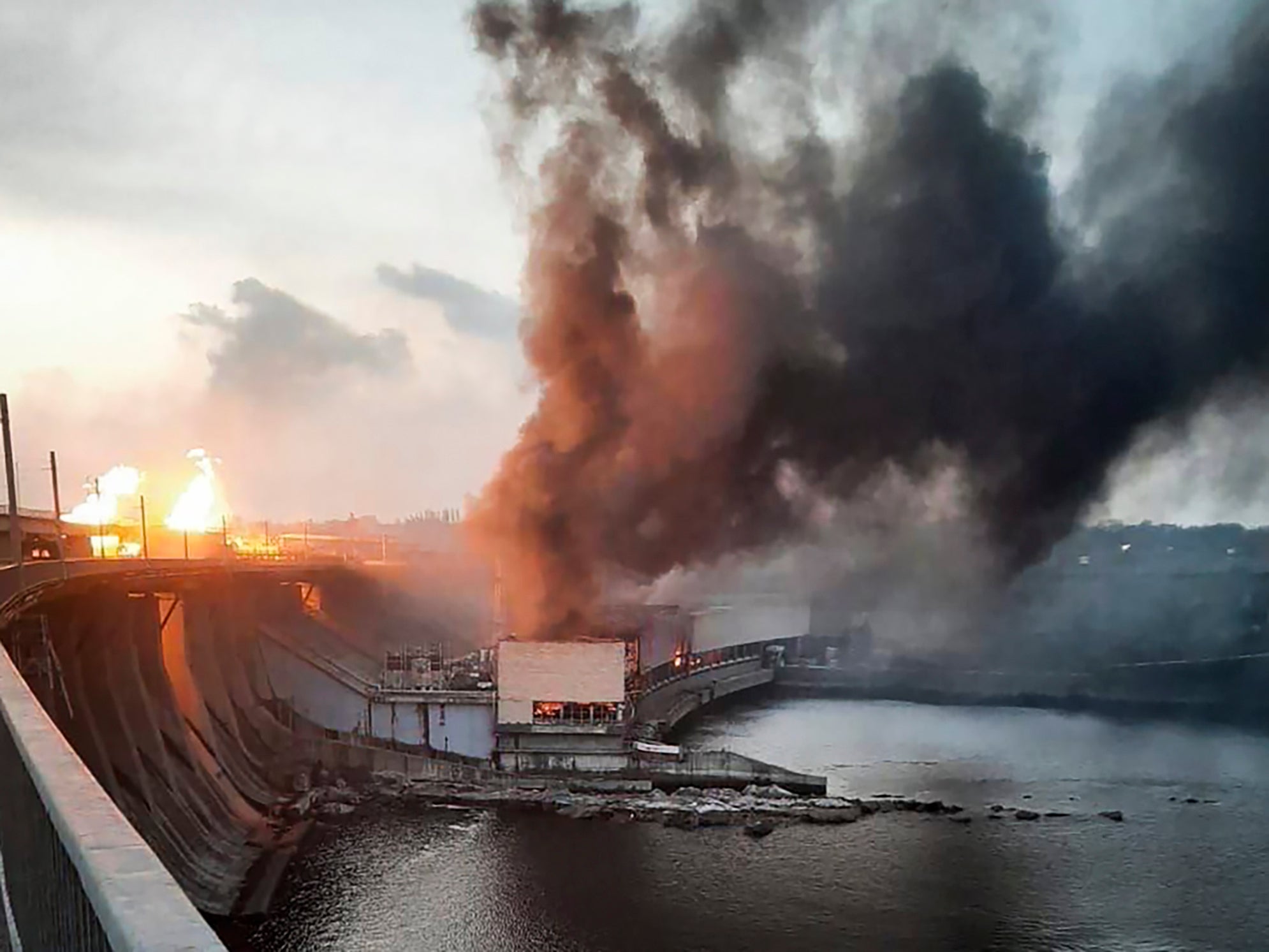 In this photo provided by Telegram Channel of Ukraine’s prime minister Denys Shmyhal, smoke and fire rise over the Dnipro hydroelectric power plant after Russian attack