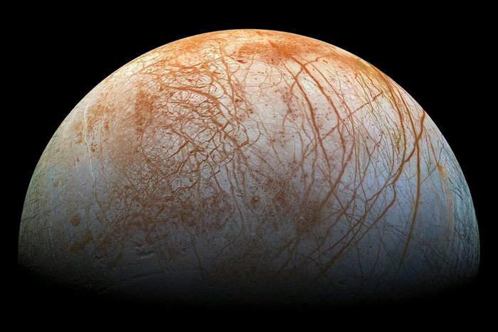 This image shows red streaks across the surface of Europa, the smallest of Jupiter’s four large moons