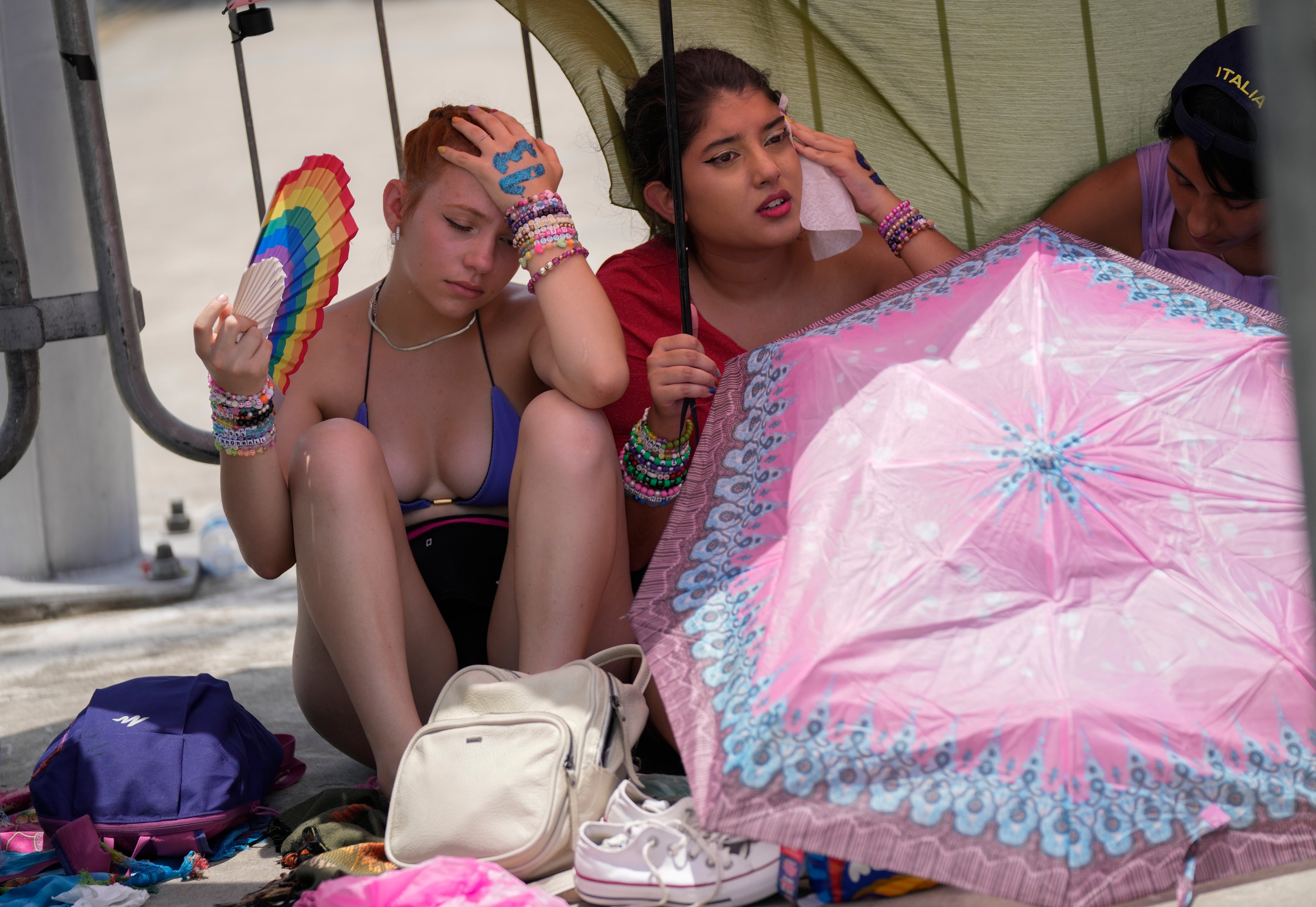 Taylor Swift fans wait for the doors of the Nilton Santos Olympic stadium to open amid a heat wave