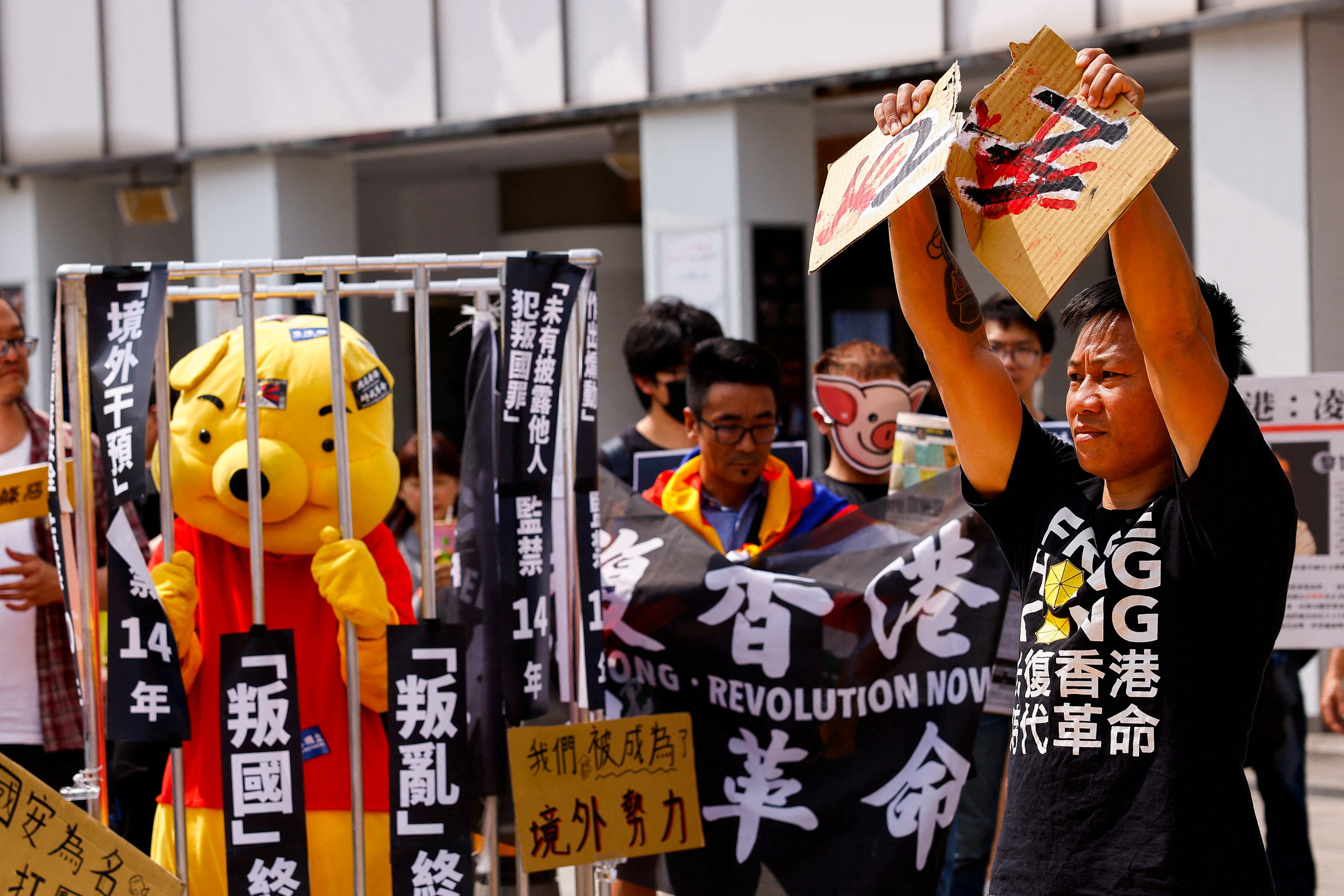 File image: Henry Tong, an exiled Hong Kong activist who is currently living in Taiwan, tears apart a cardboard with 23 on it, during a protest against Hong Kong's Article 23 national security law in Taipei, Taiwan