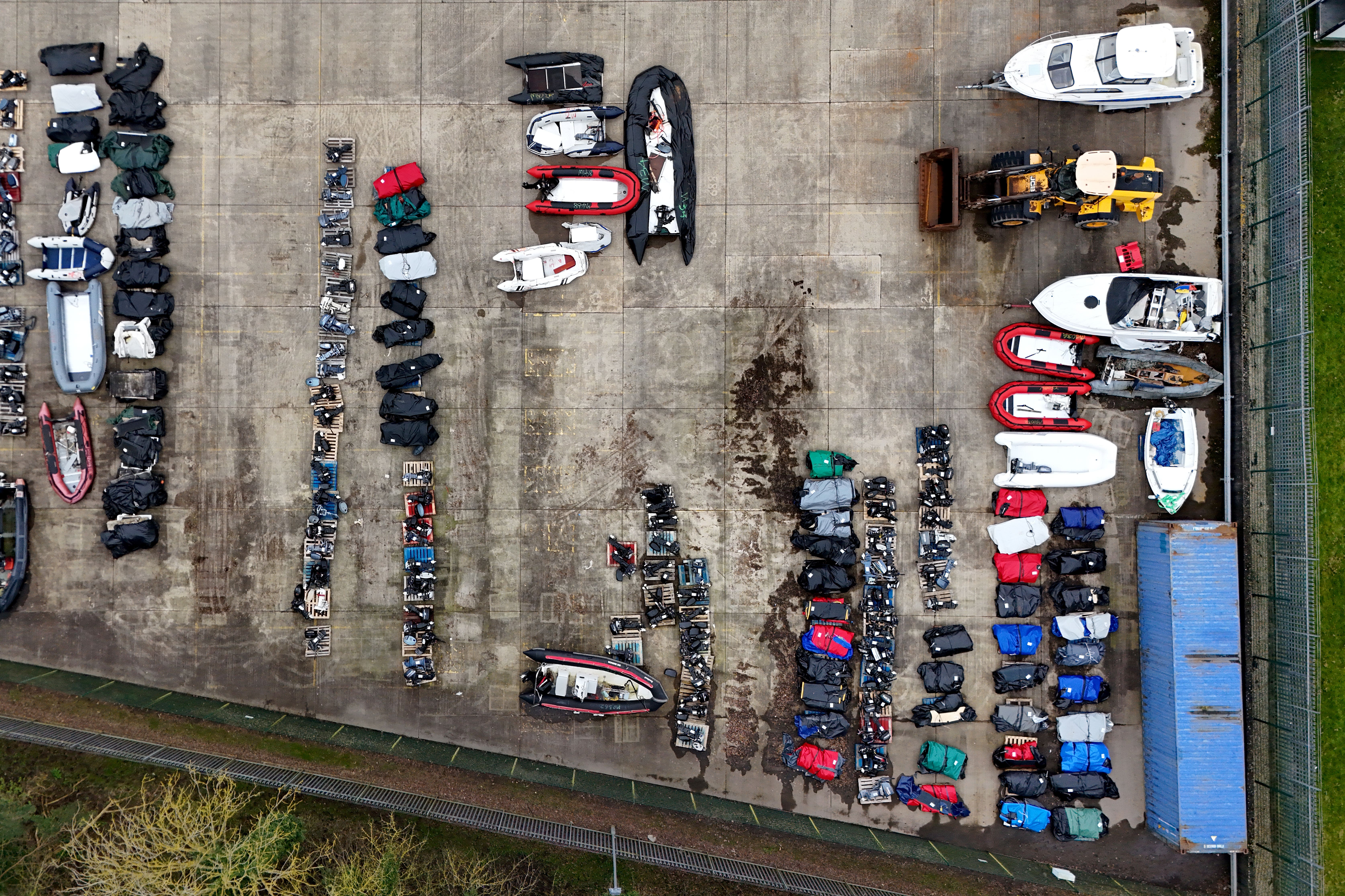 A view of small boats and engines used to cross the Channel by people thought to be migrants at a warehouse facility in Dover, Kent (Gareth Fuller/PA)