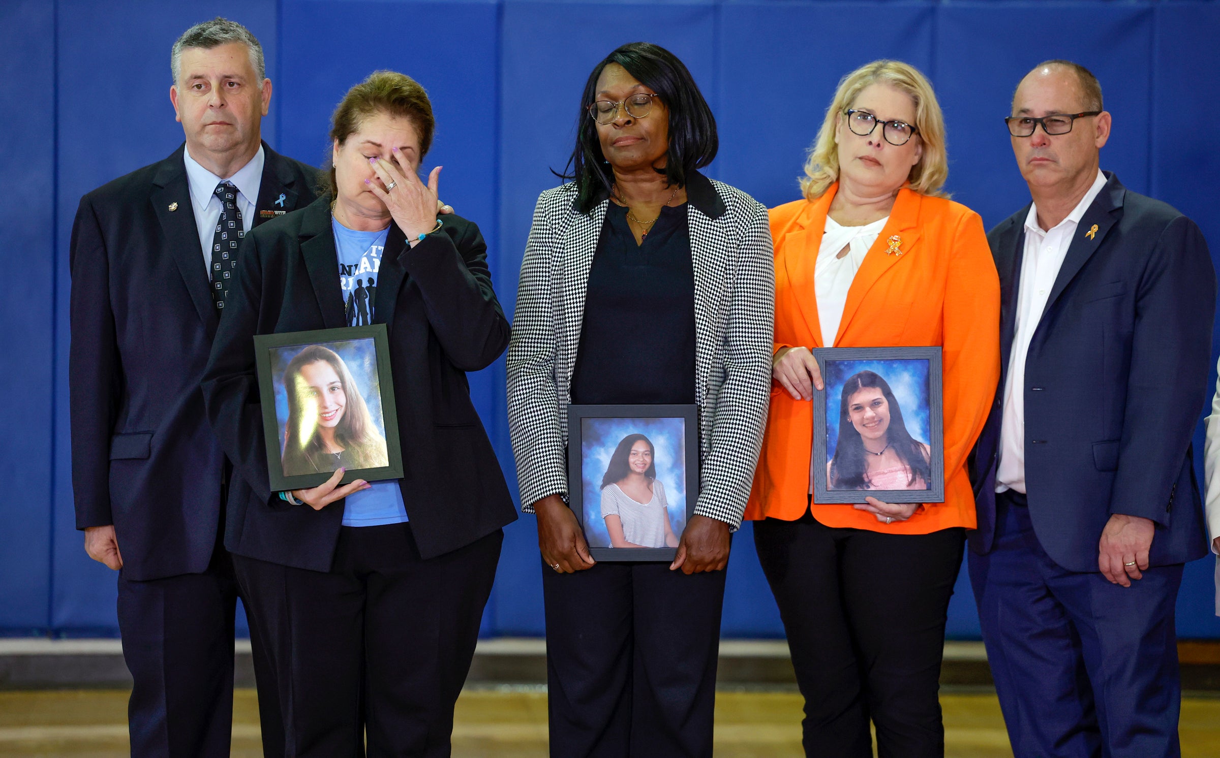 The family of students who were killed during the shooting at Marjory Stoneman Douglas High School six years earlier react as Vice President Kamala Harris speaks during a visit to the school in Parkland, Florida