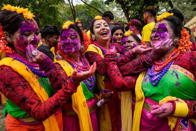<p>Women put coloured powder on each other as they celebrate Holi, the festival of colors, in Kolkata, India</p>