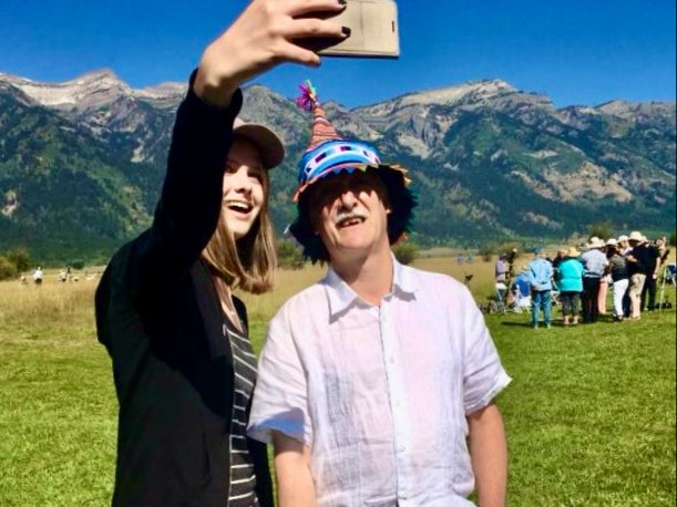 Selfie star: Dr John Mason, wearing his special eclipse headgear, with a young astronomical fan in Wyoming ahead of the 2017 eclipse