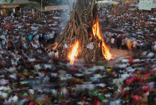 <p>File. Hindus walk around a bonfire during a ritual as part of the Holi festival celebrations in Ahmedabad, India </p>