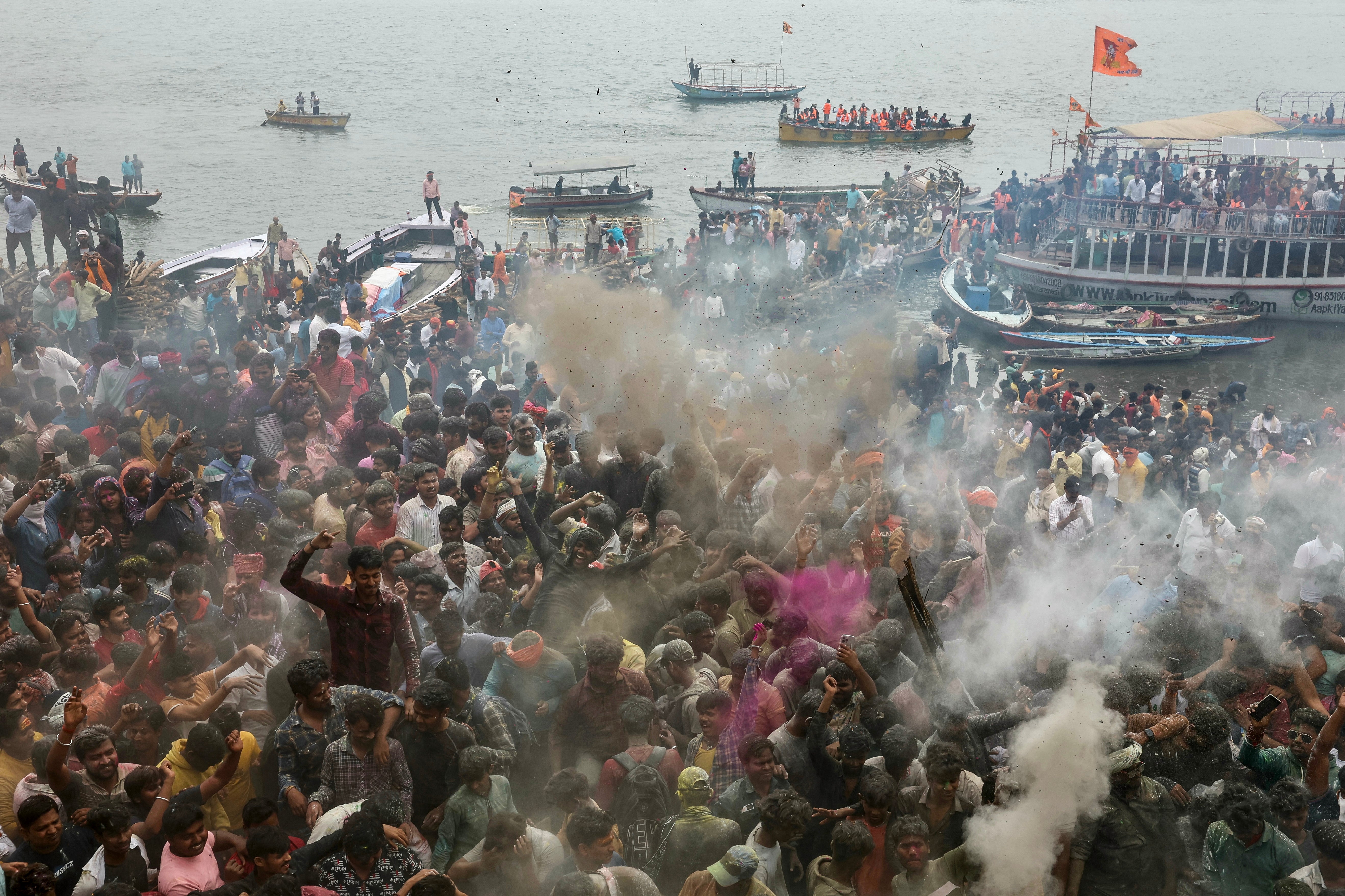 Hindu devotees gather at the Manikarnika Ghat as they take part in the 'Masaan or Bhasma' Holi, celebrated with ashes of funeral pyres, in Varanasi