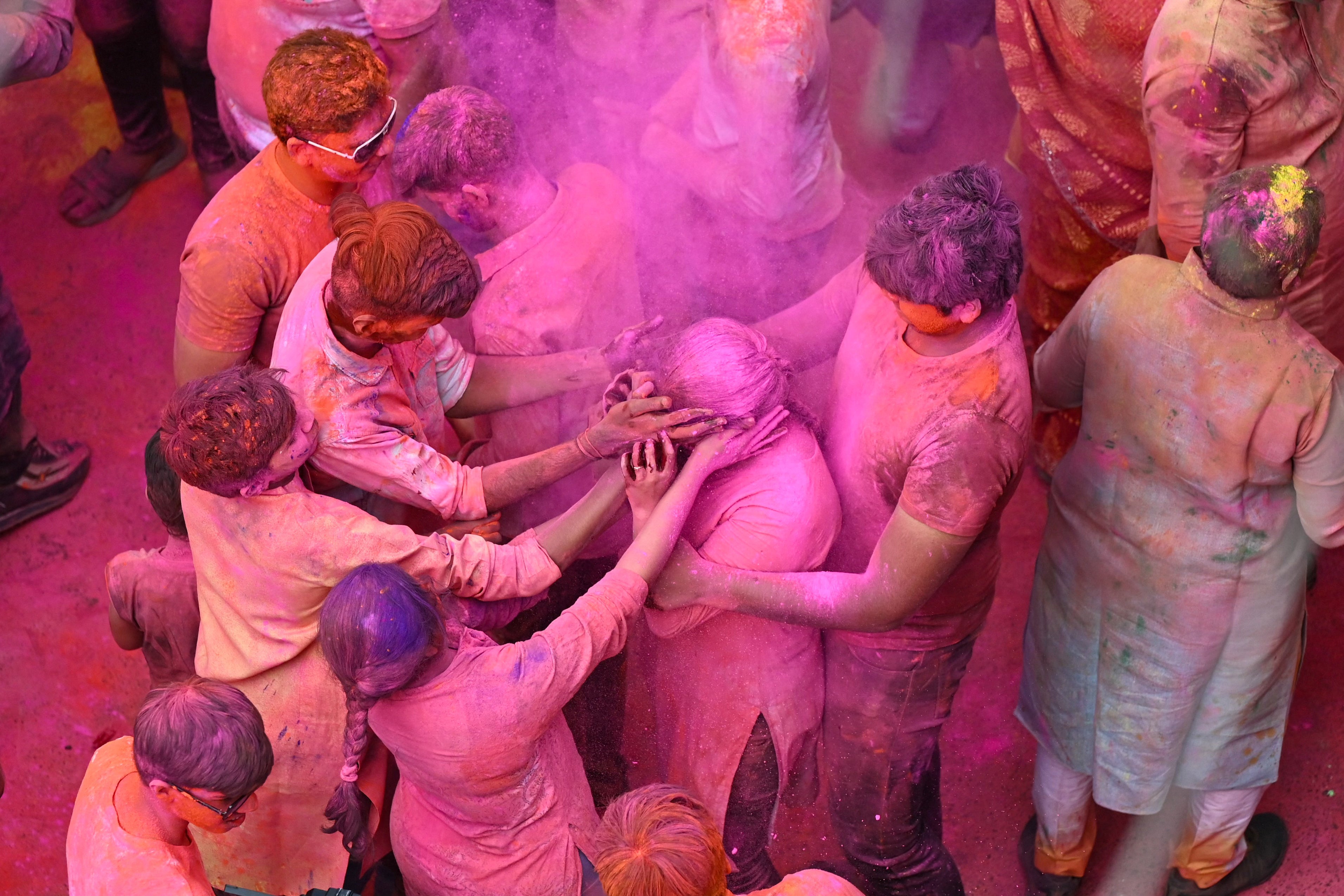 People smeared with ‘Gulal’ as they celebrate Holi, the Hindu spring festival of colours, in Hyderabad