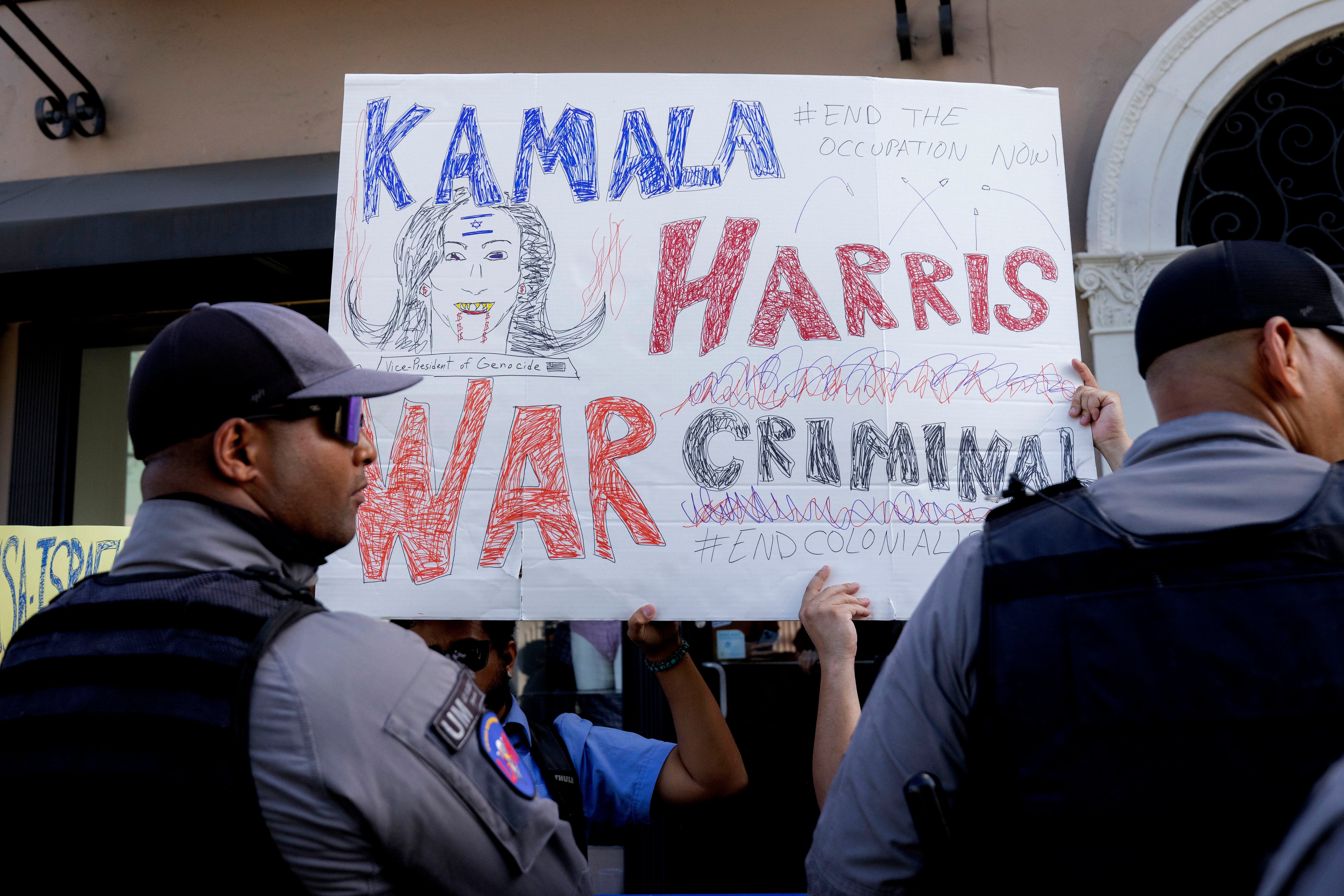 People protest outside the facility where Vice President Kamala Harris is holding a meeting, in San Juan, Puerto Rico