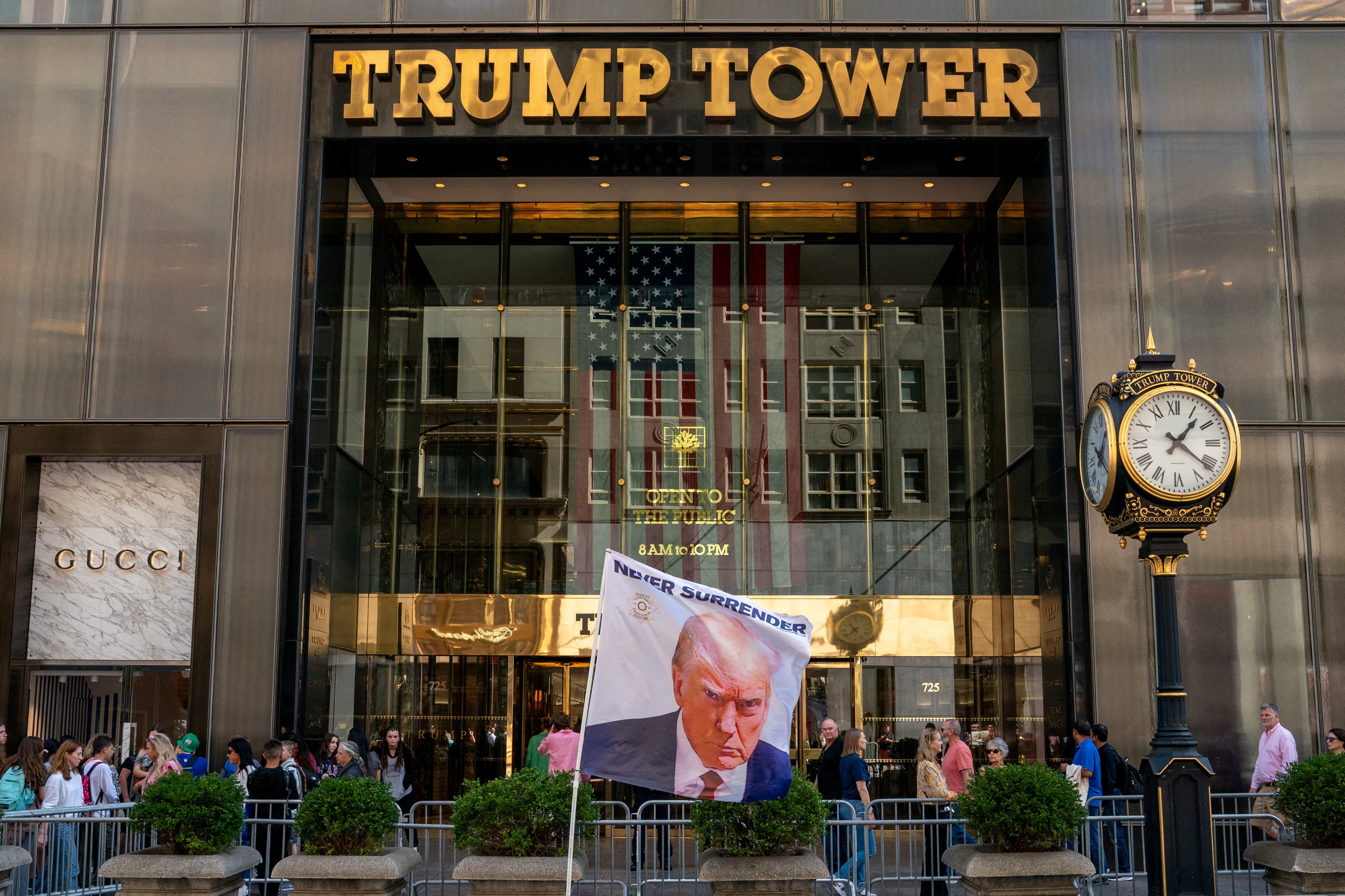 A flag depicting Mr Trump is placed at Trump Tower in New York City