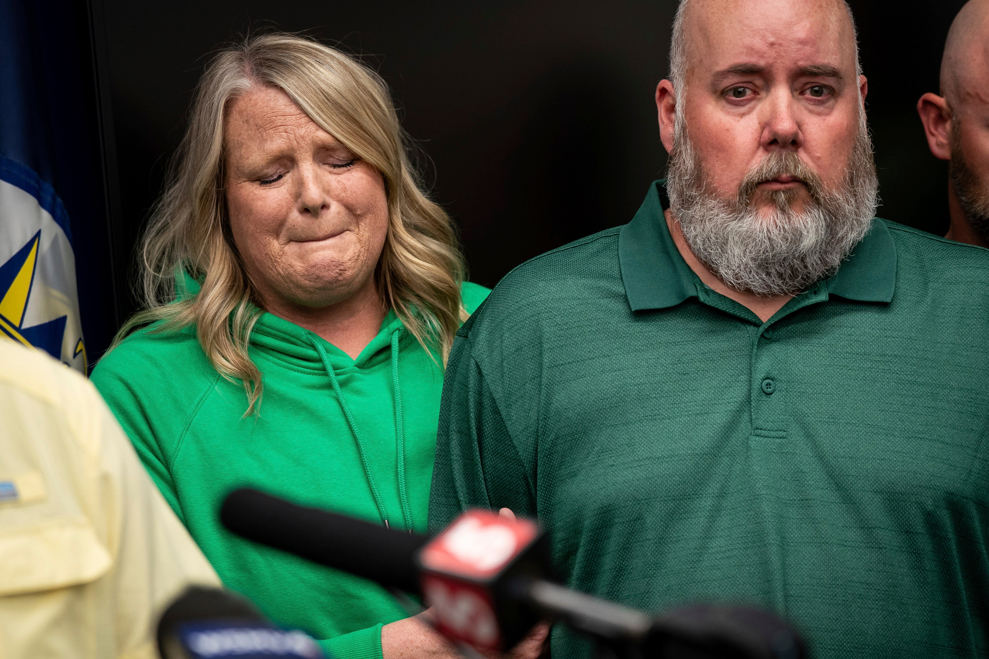 Michelle Strain Whiteid, left, mother of Riley Strain, holds on to the arm of her husband, Chris Whiteid, during a news conference at the Metro Nashville Police Department headquarters in Nashville