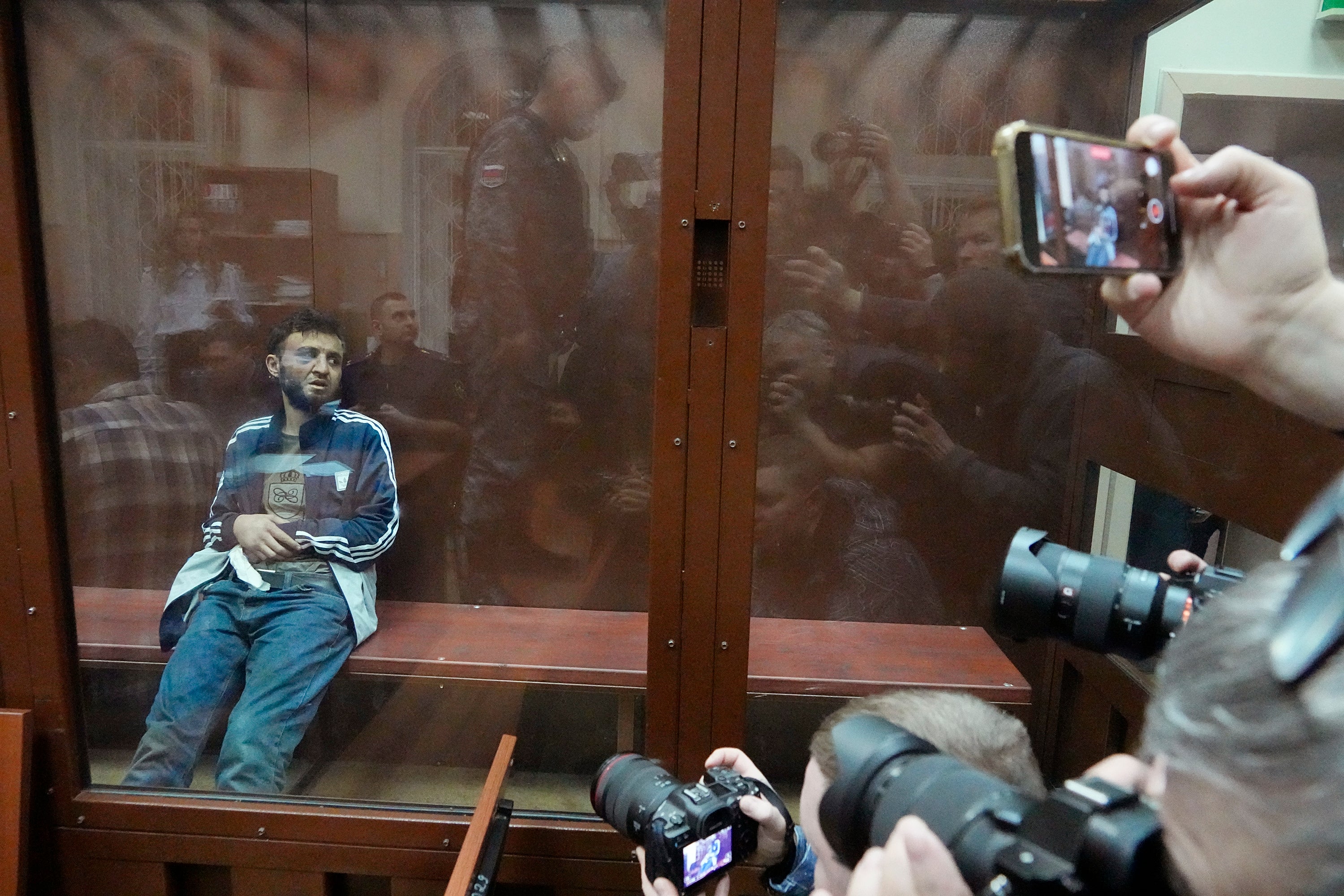 Dalerdzhon Mirzoyev, a suspect in the Crocus City Hall shooting on Friday sits in a glass cage in the Basmanny District