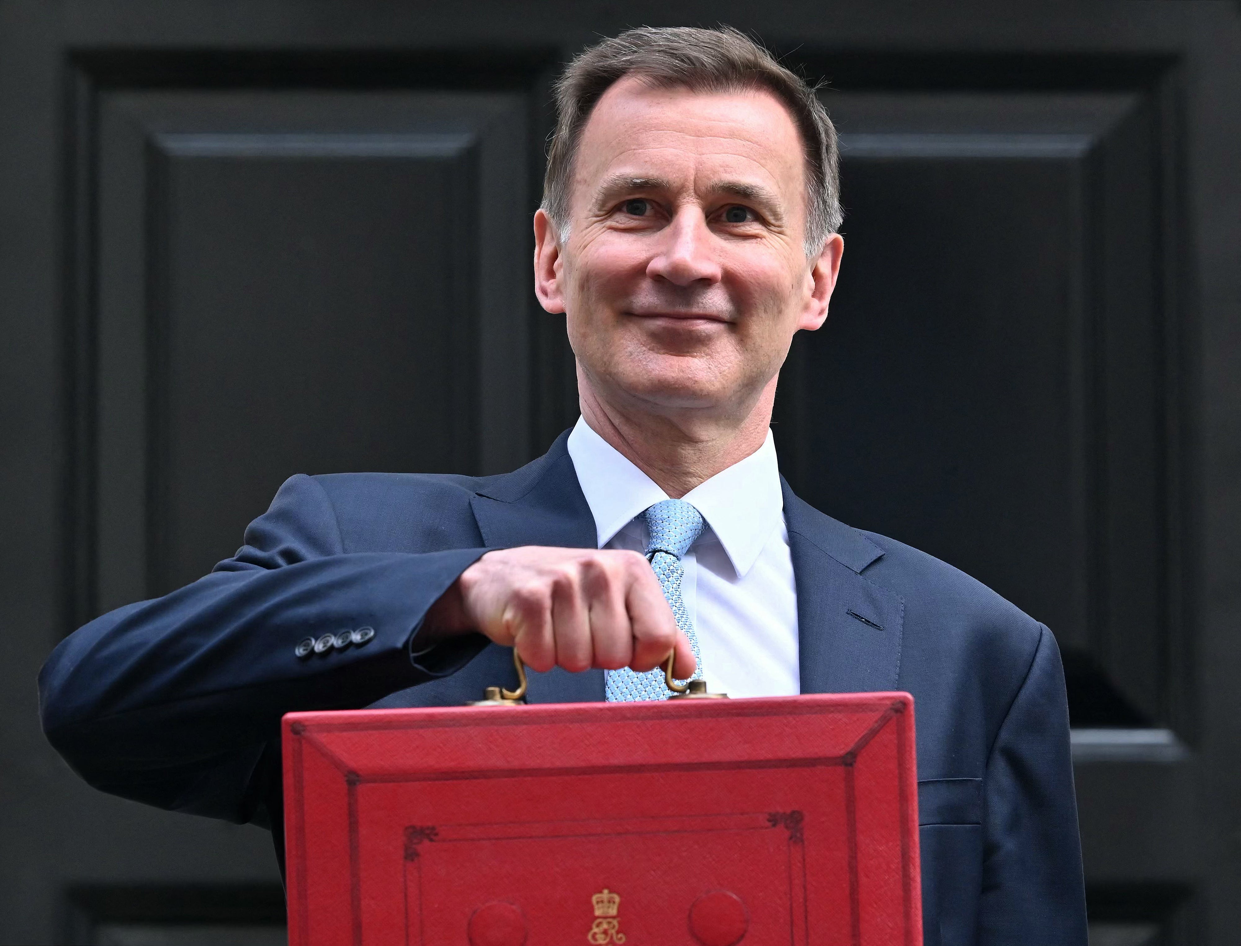 Jeremy Hunt poses with the red Budget box, 6 March 2024