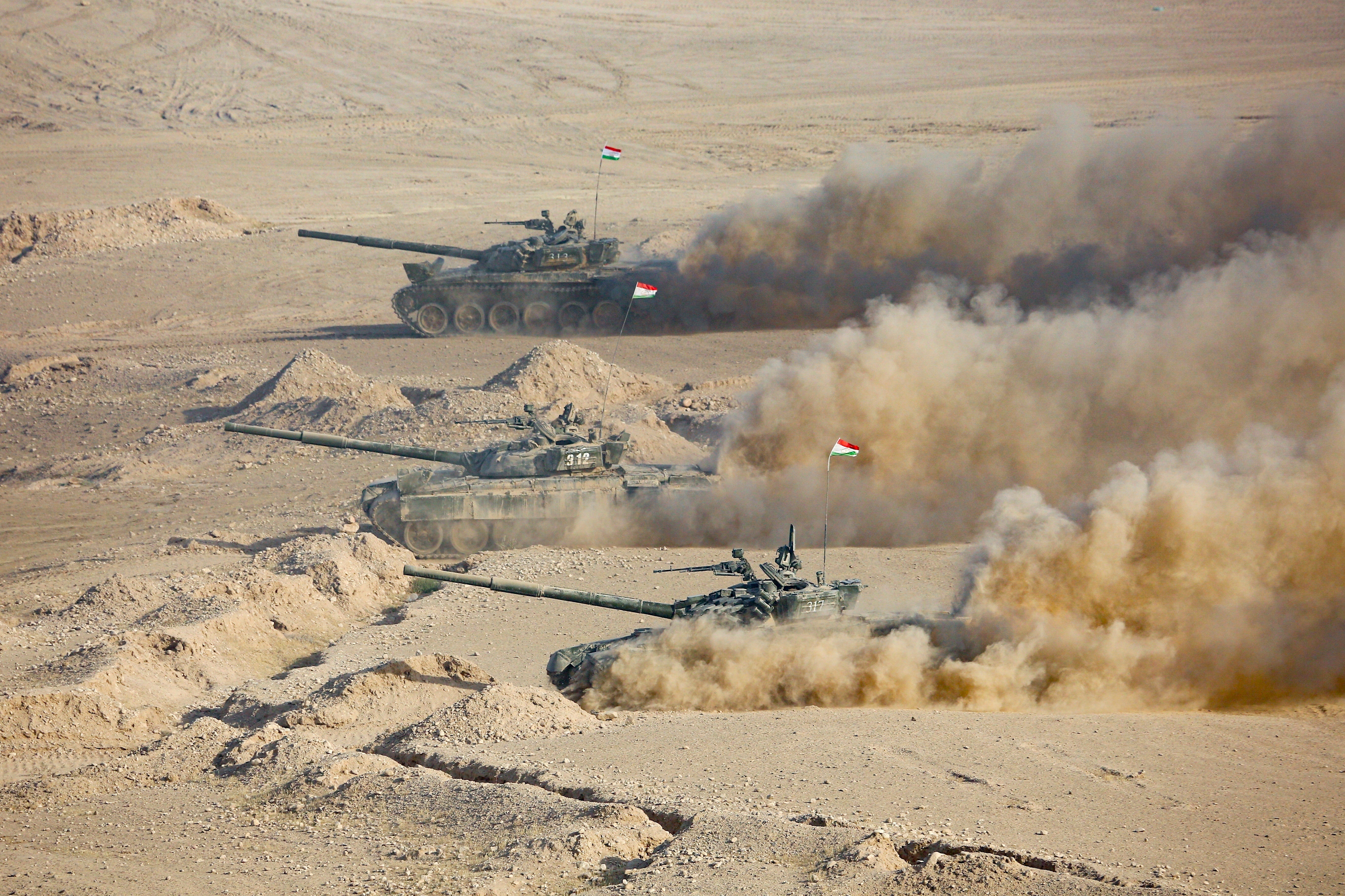 Tajikistan’s tanks roll during a joint military drills by Russia and Uzbekistan at Harb-Maidon firing range