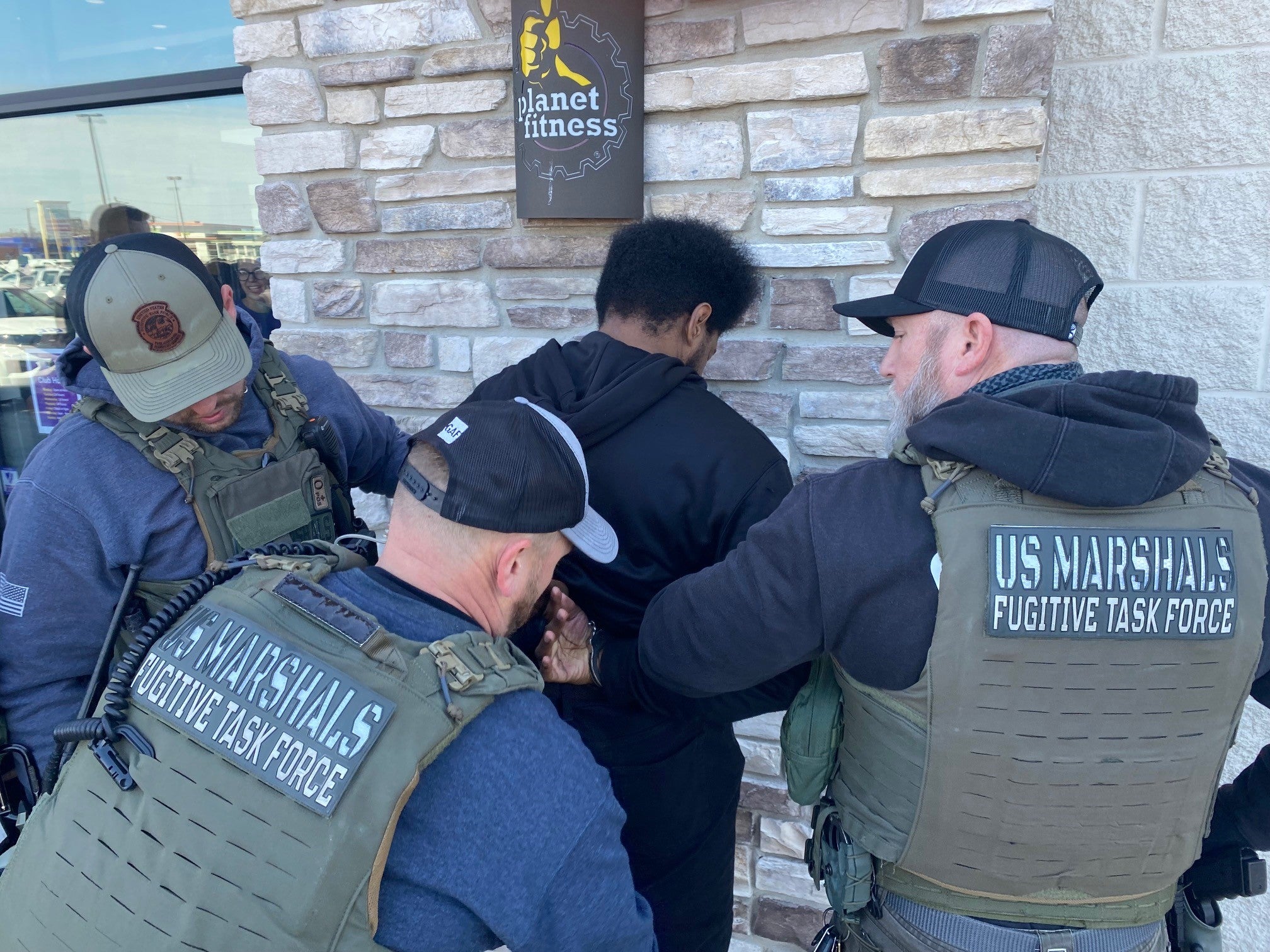<p>US Marshals arrest Isaiah Tilghman outside a Planet Fitness in Philadelphia on Friday 22 March 2024</p>