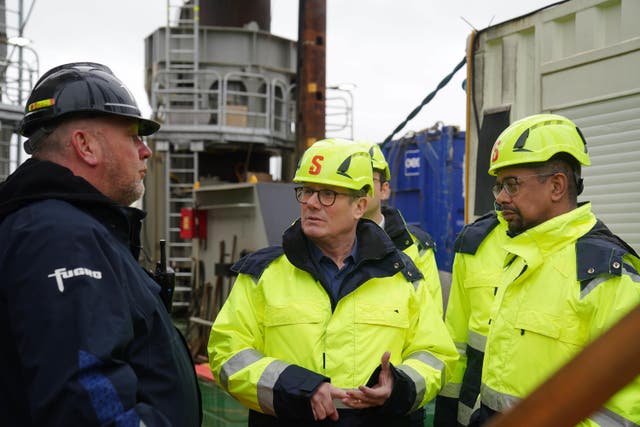 Labour leader Sir Keir Starmer, centre, and new Welsh First Minister Vaughan Gething, right, during a visit to the Port of Holyhead in North Wales (Peter Byrne/PA)