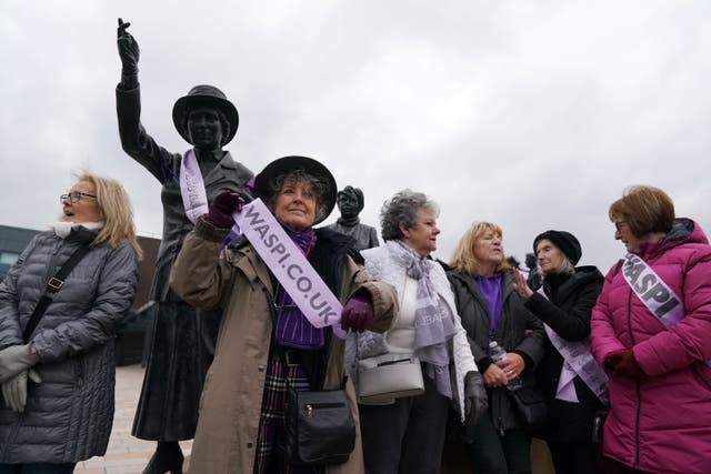 Campaigners for Women Against State Pension Inequality gather at the statue of political activist Mary Barbour (Andrew Milligan/PA)