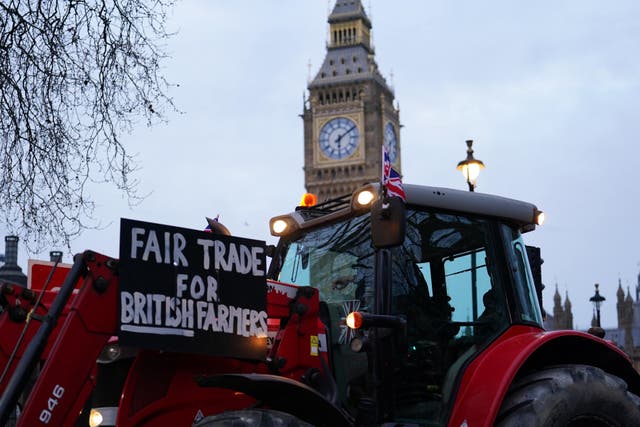 <p>Farmers take part in a tractor ‘go-slow’ through Parliament Square (Jordan Pettitt/PA)</p>