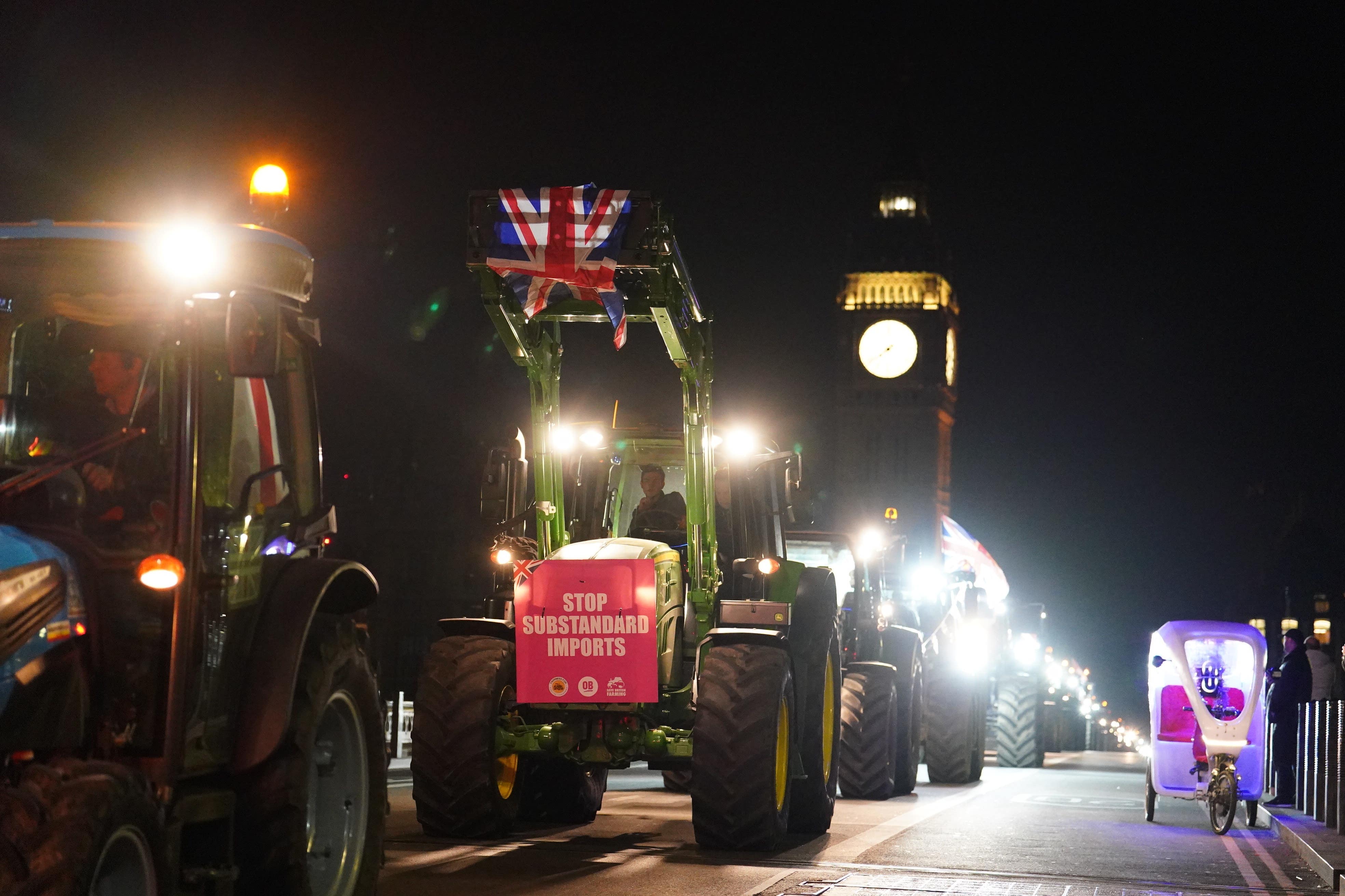 Farmers take part in a tractor ‘go-slow’ near the Palace of Westminster (Jordan Pettitt/PA)
