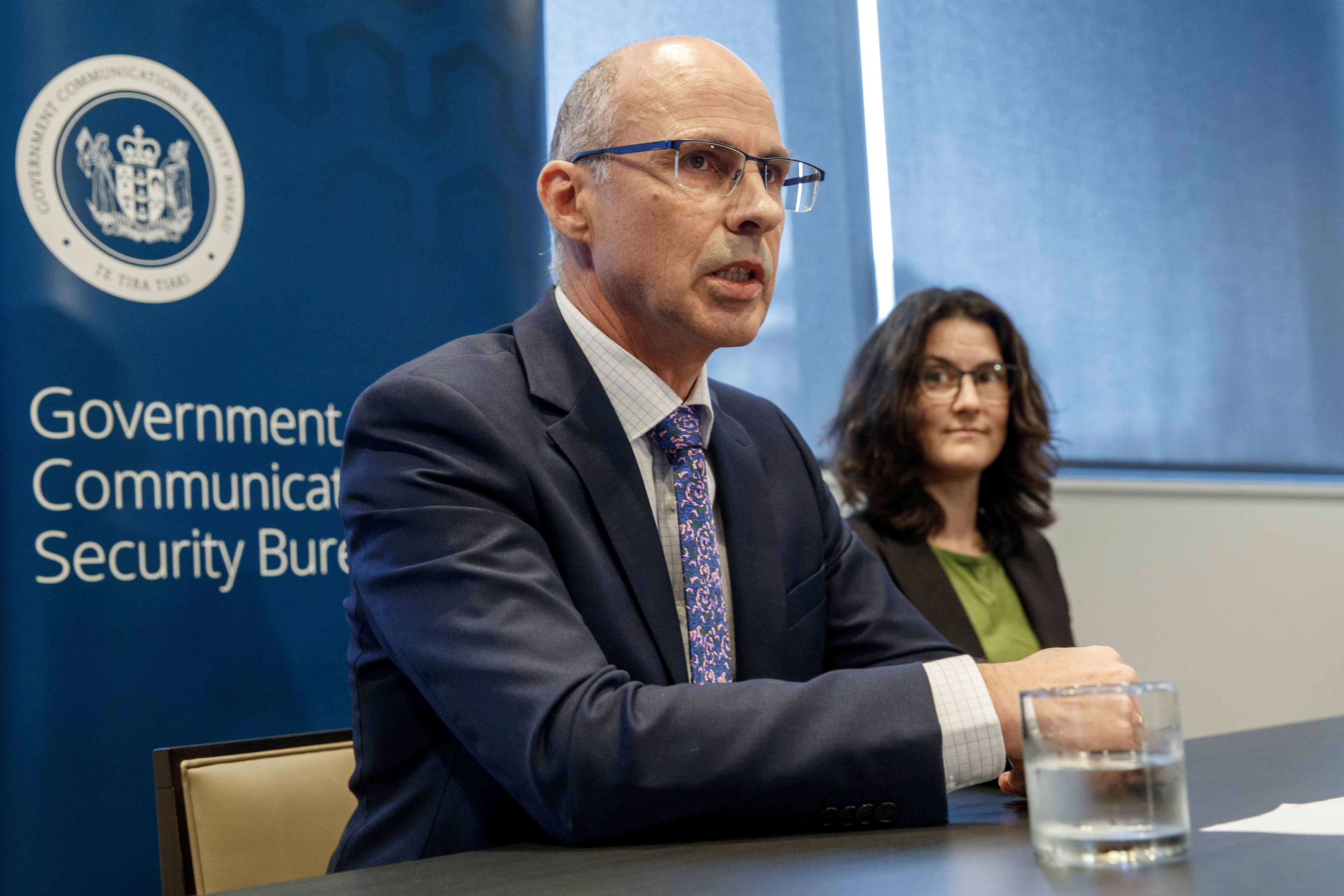 New Zealand's Government Communications Security Bureau Director-General Andrew Clark, left, and the Deputy Director-General Lisa Fong speak at Defence house in Wellington