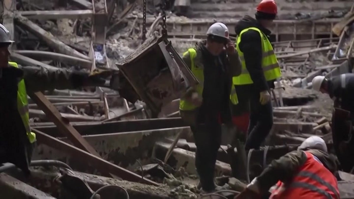 Workers clear debris at Moscow concert hall as investigation continues