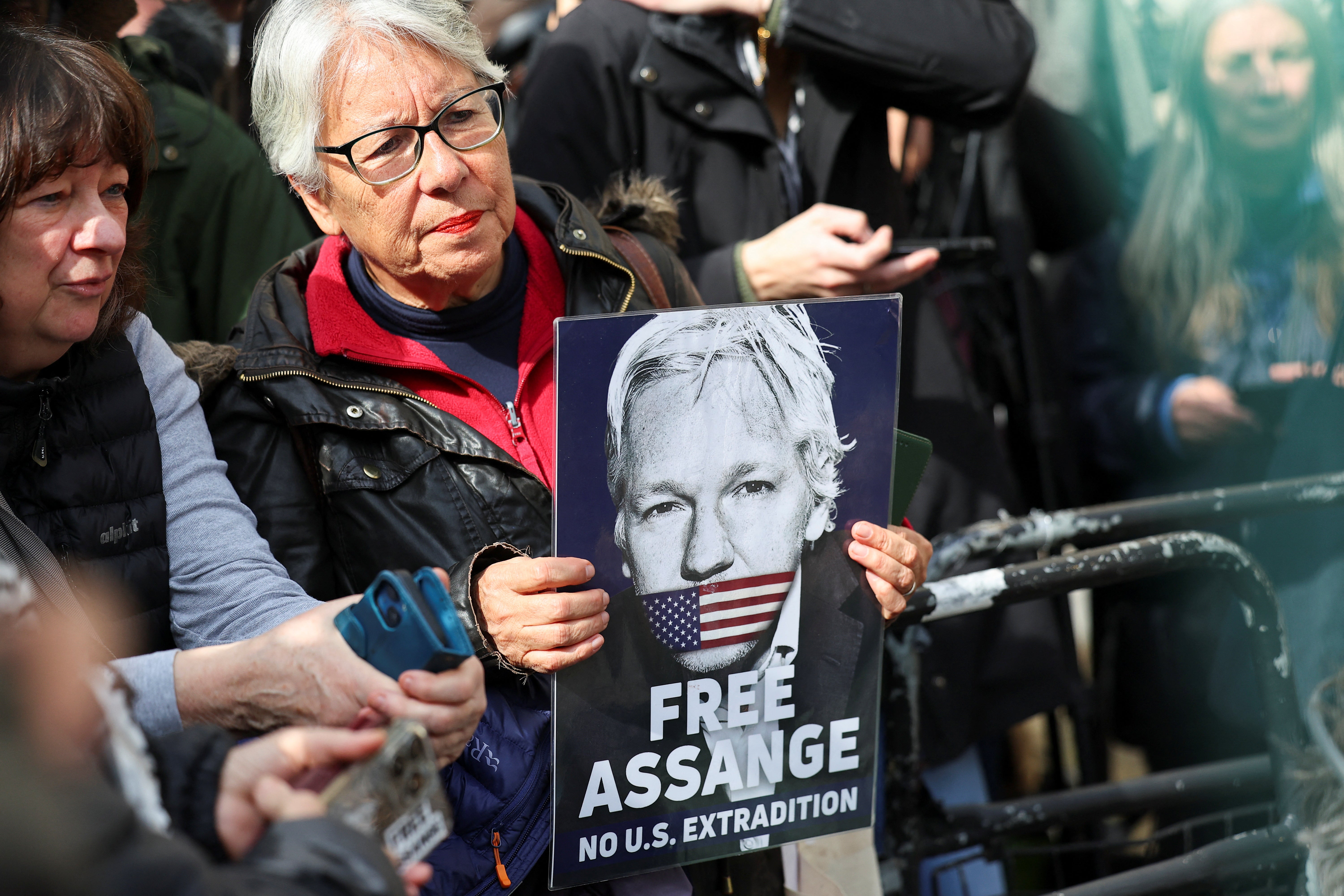 Supporters rally outside the High Court in London