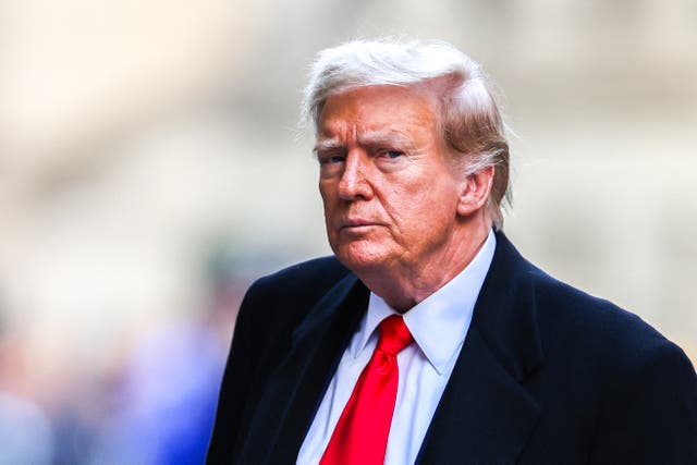 <p>Former US president Donald Trump arrives at 40 Wall Street after his court hearing to determine the date of his trial for allegedly covering up hush money payments linked to extramarital affairs in New York City on 25 March</p>