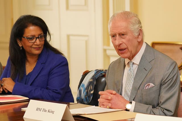 The King during a meeting in the Billiard Room at Buckingham Palace with Vijaya Nath (left), and with community faith leaders from across the UK (Jonathan Brady/PA)