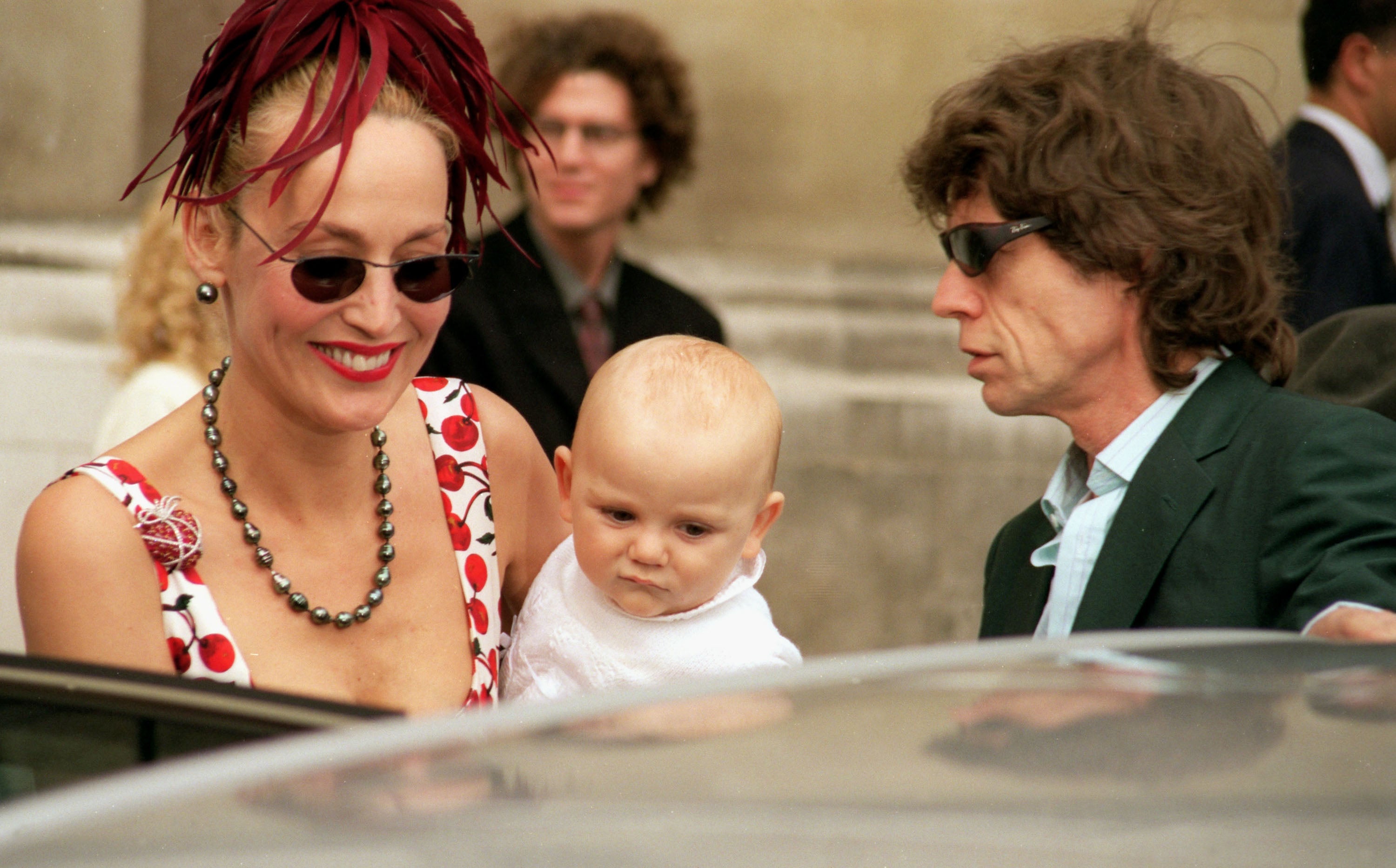 Rolling Stones’ singer Mick Jagger and model Jerry Hall with their baby, Gabriel, attend the wedding of Princess Maria-Theodora ‘Dora’ Loewenstein to Manfredi Gherardesca at the Brompton Oratory on September 27, 1998 in London