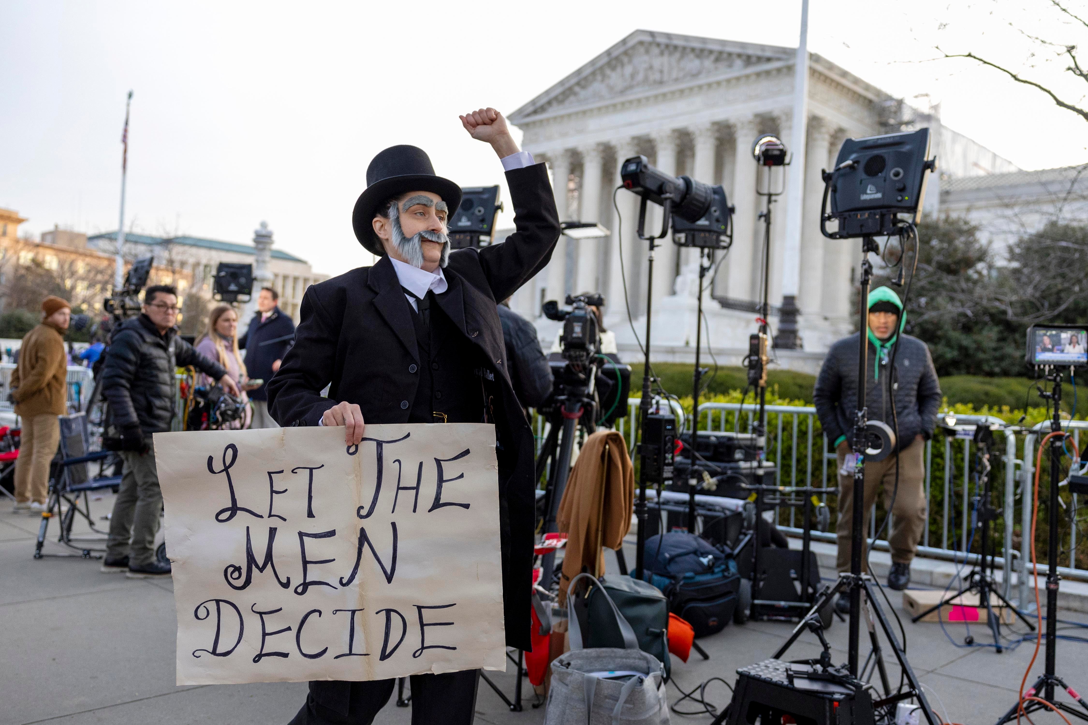 Molly Gaebe of the Abortion Access Front protests outside the US Supreme Court on 26 March dressed as 19th century anti-vice crusader Anthony Comstock.
