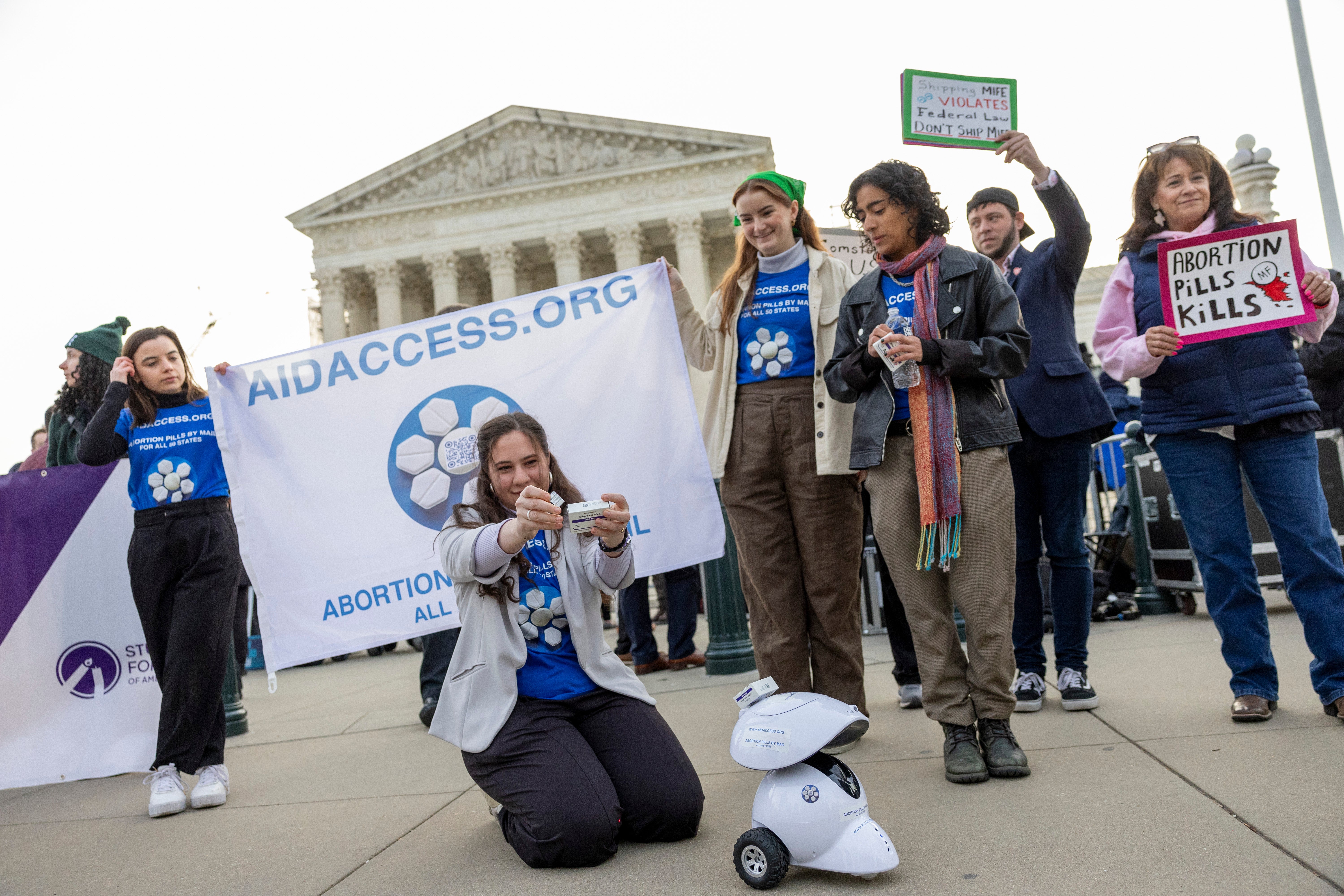 Mira Michels of Aid Access prepares to take the mifepristone pill in protest outside the US Supreme Court on 26 March.