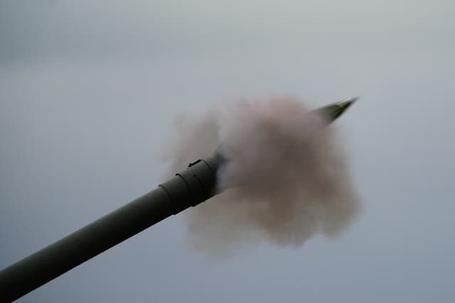 Newly trained Ukrainian artillery specialists firing British donated AS90 155mm self-propelled artillery guns under the supervision of British Army instructors as they come to the end of their training in south west England (Ben Birchall/PA)